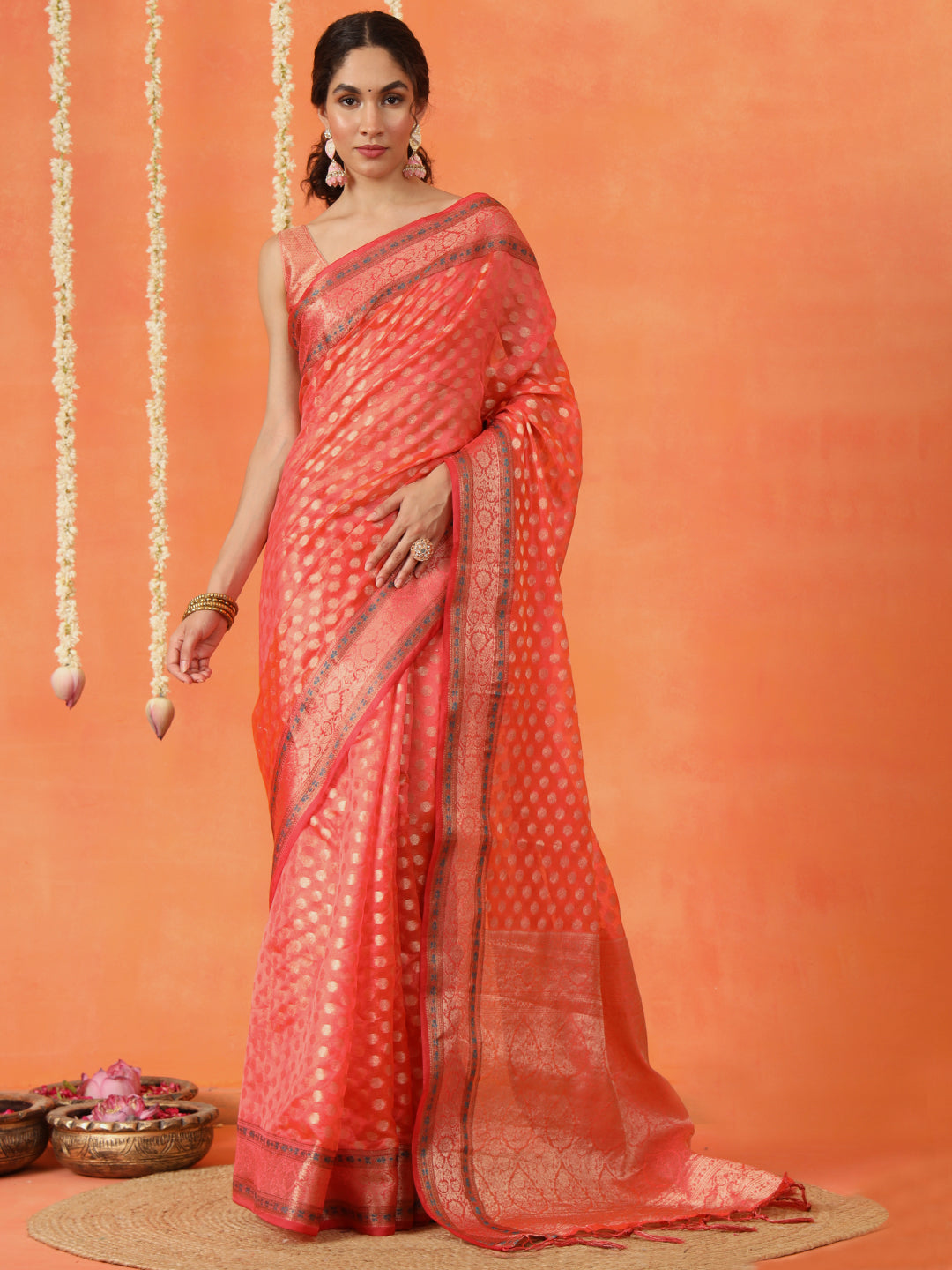 Peach colored art silk woven designer saree with tassles on pallu