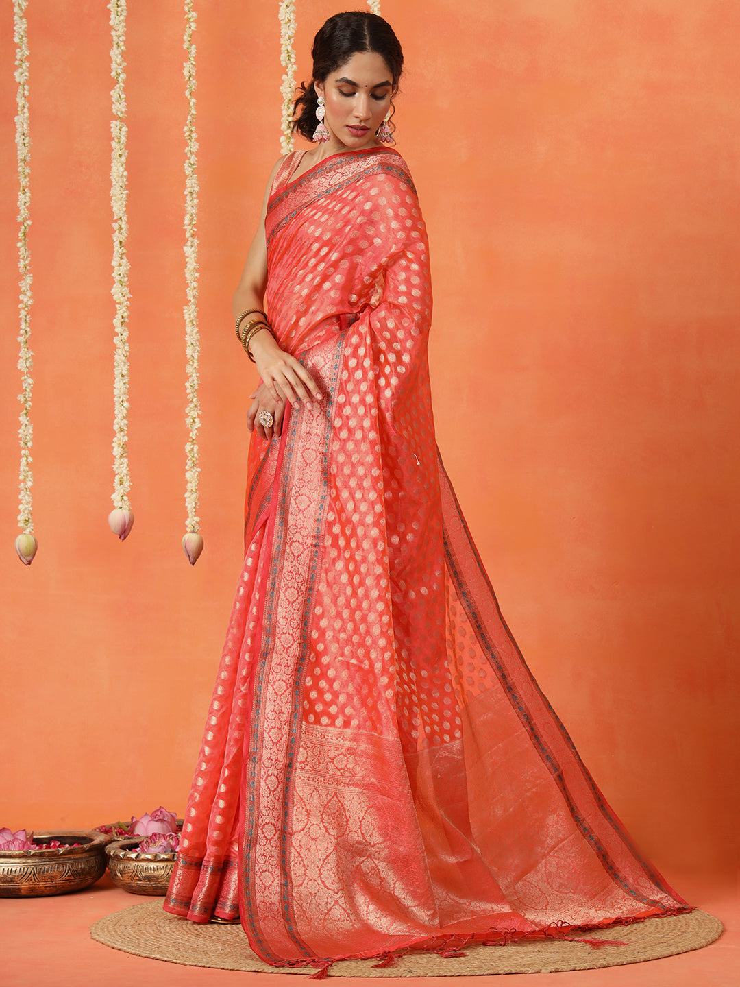 Peach colored art silk woven designer saree with tassles on pallu