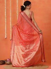 Peach colored art silk woven designer saree with tassles on pallu