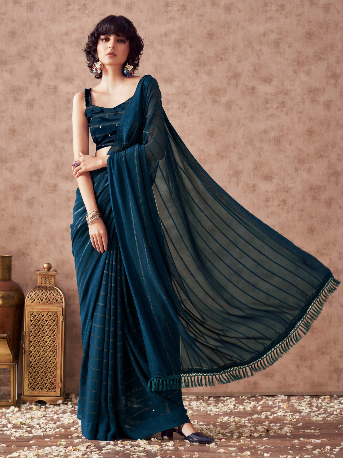 Teal colored striped saree with embroidered blouse