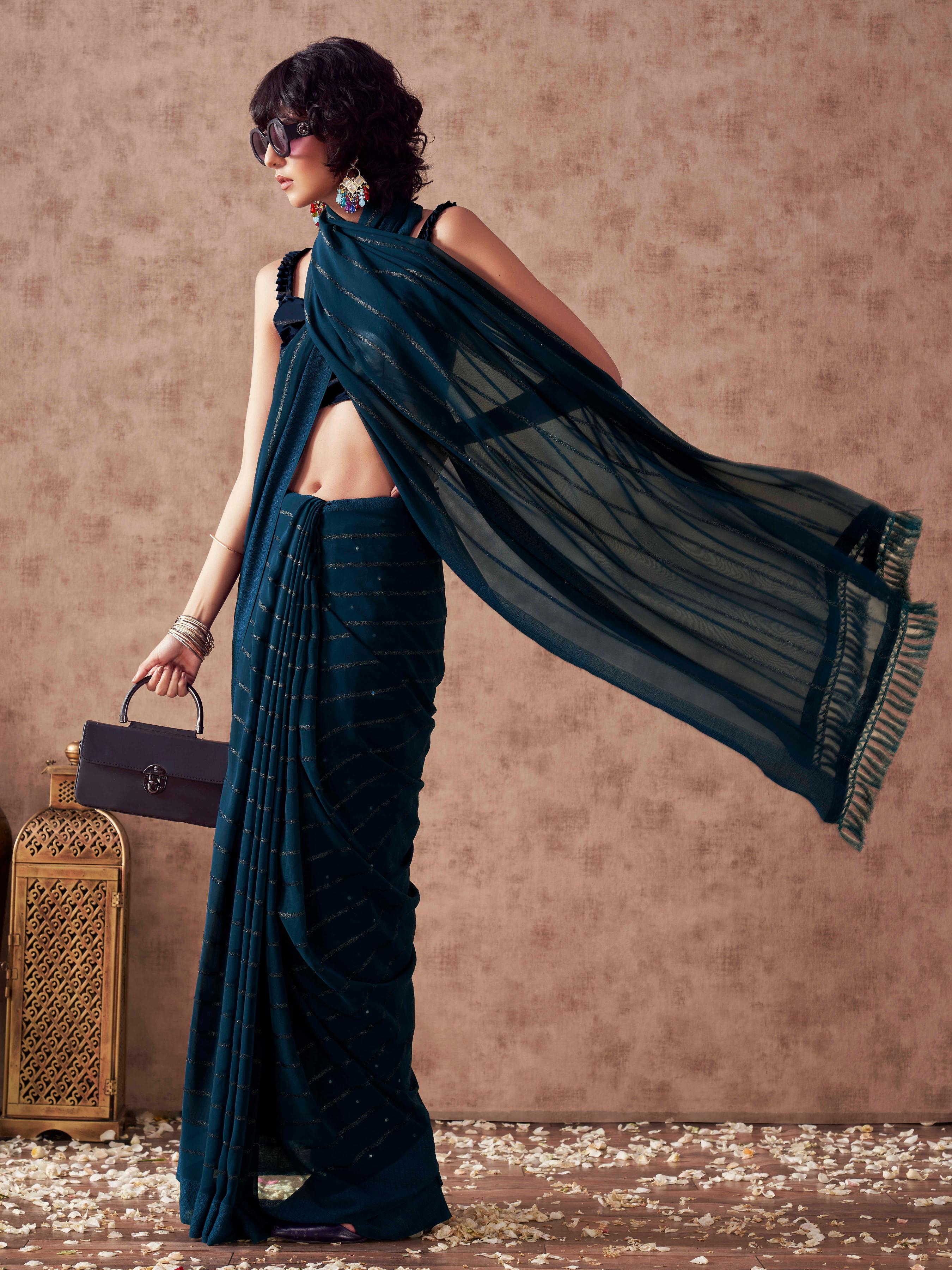 Teal colored striped saree with embroidered blouse