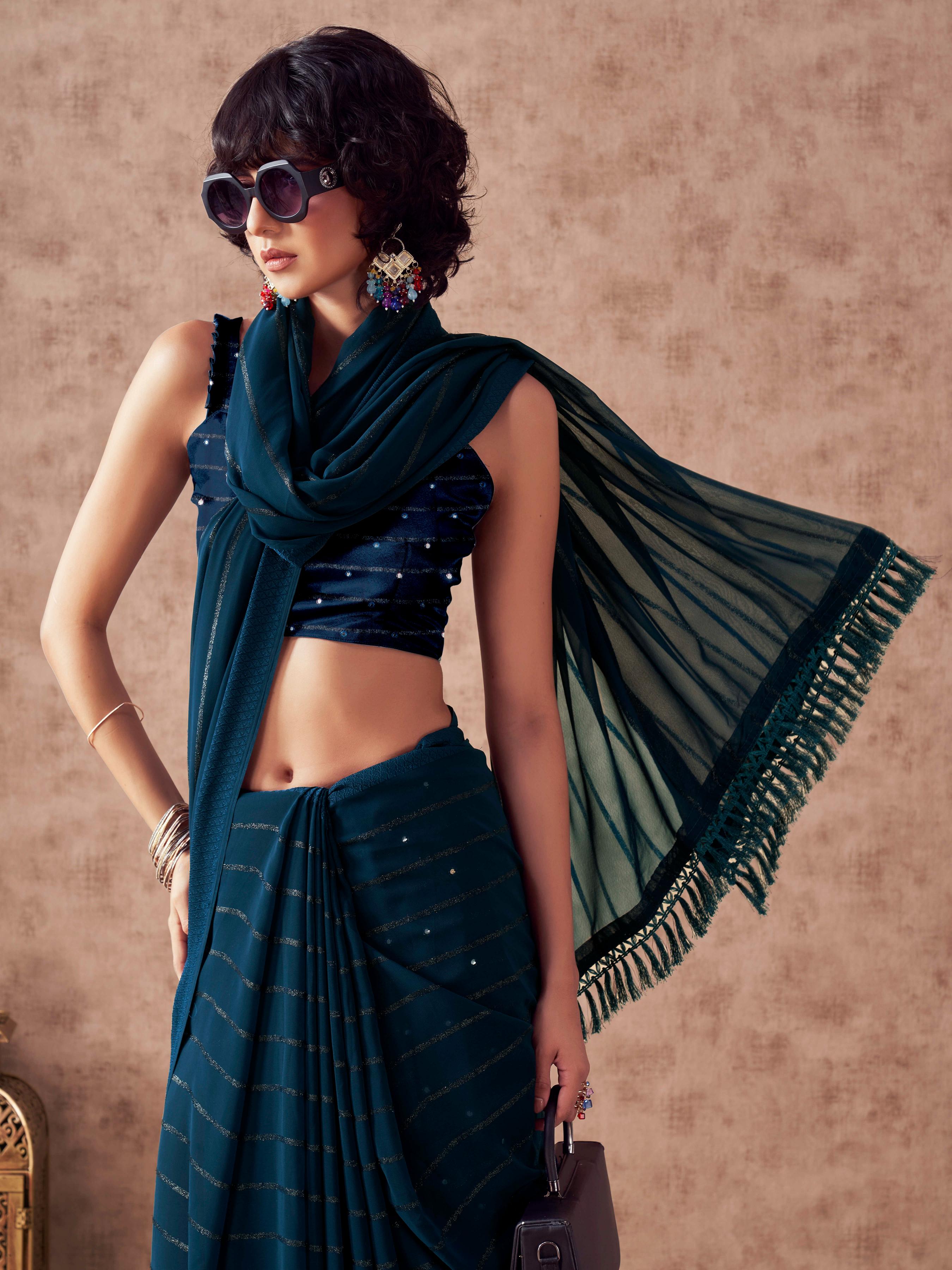 Teal colored striped saree with embroidered blouse