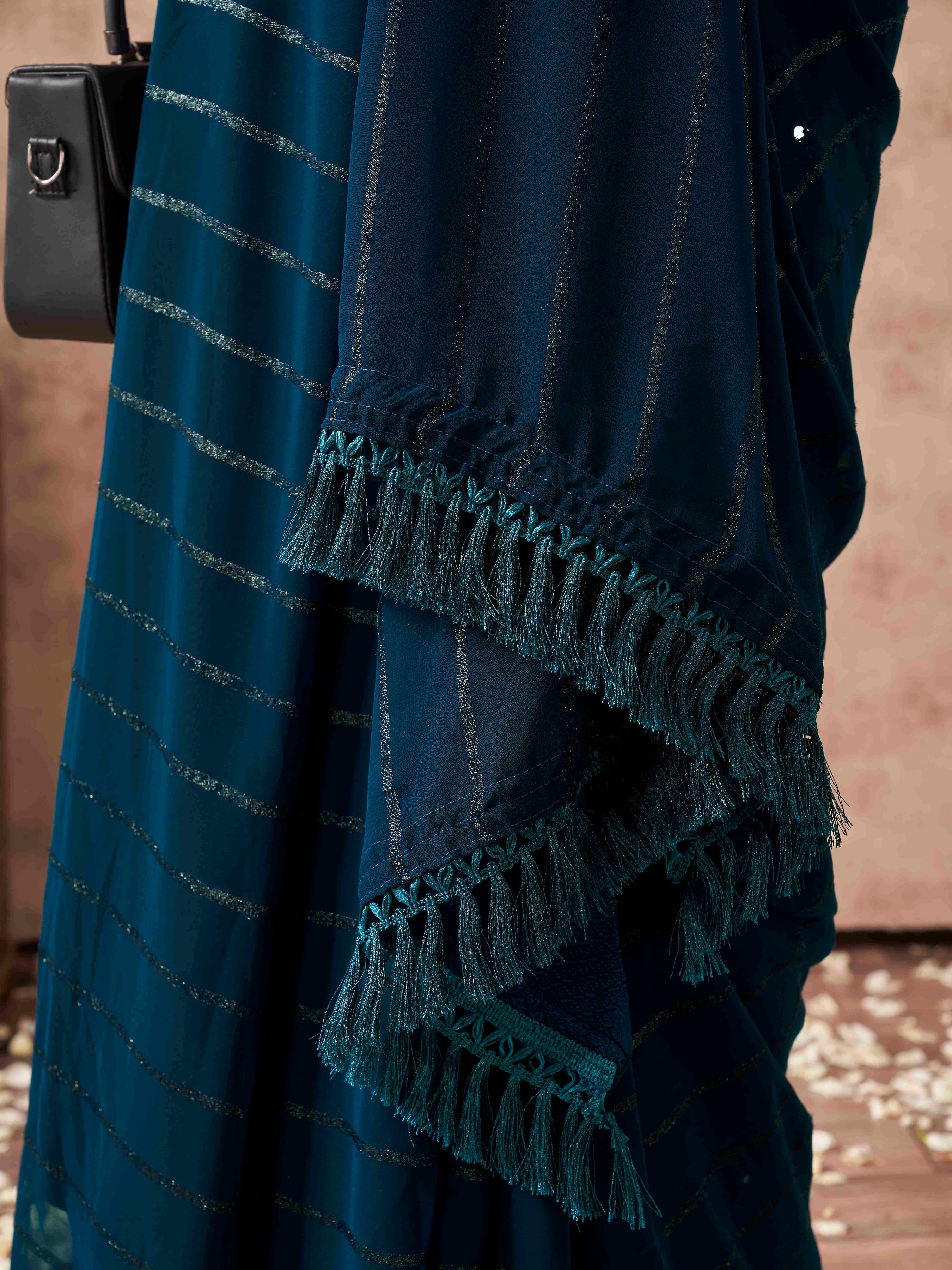 Teal colored striped saree with embroidered blouse