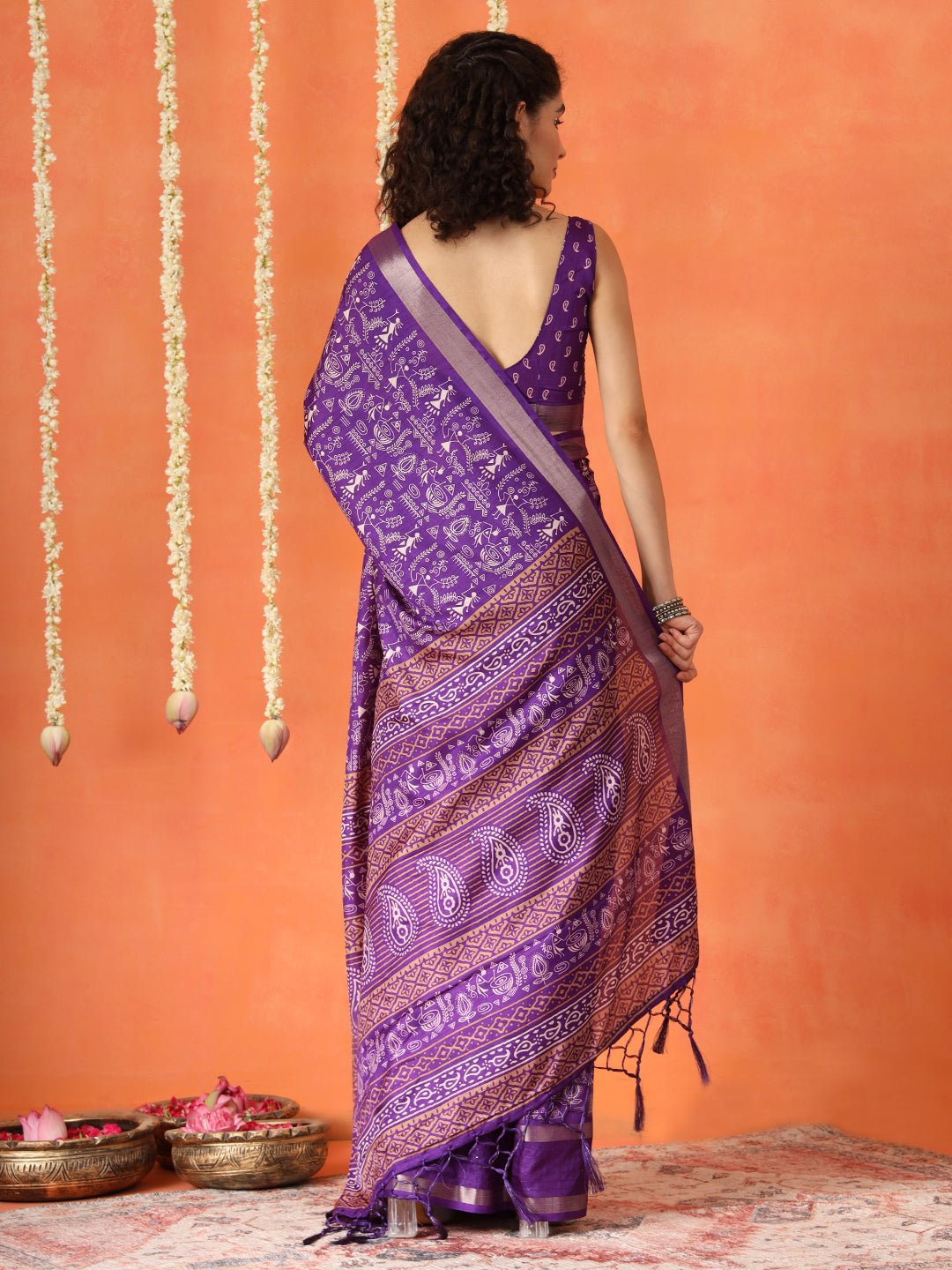 Purple colored traditional printed poly cotton saree with tassles on pallu