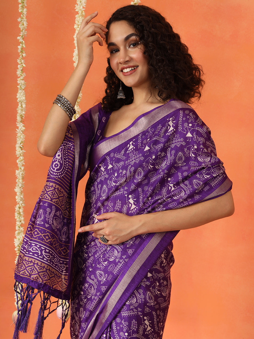 Purple colored traditional printed poly cotton saree with tassles on pallu