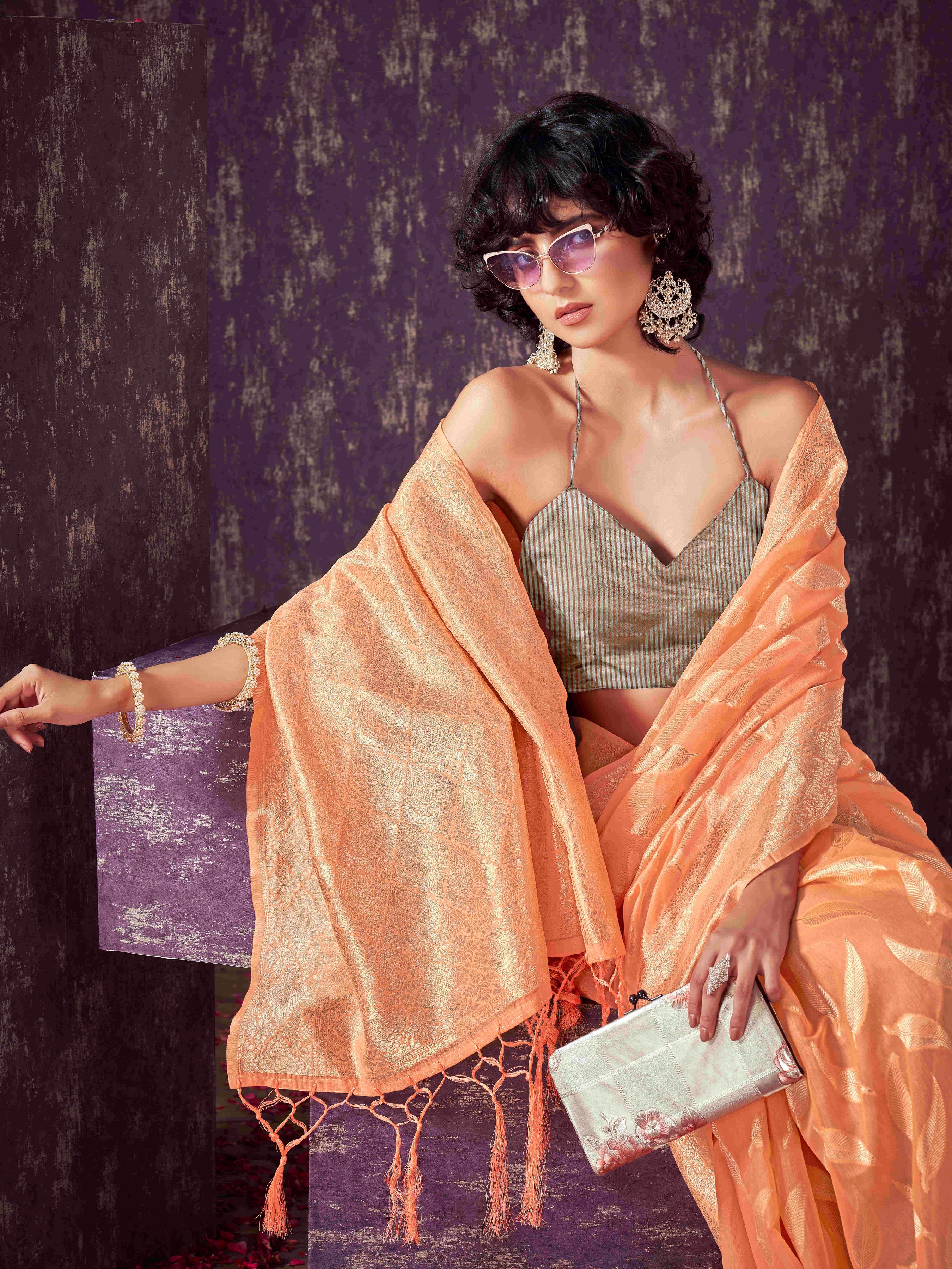 Peach colored poly cotton woven designer saree with tassles on pallu