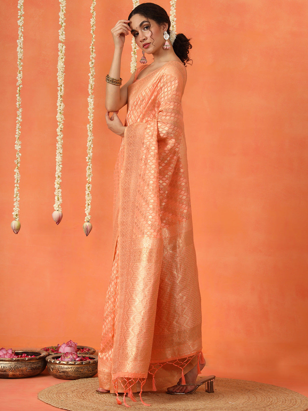 Peach colored poly cotton woven designer saree with tassles on pallu