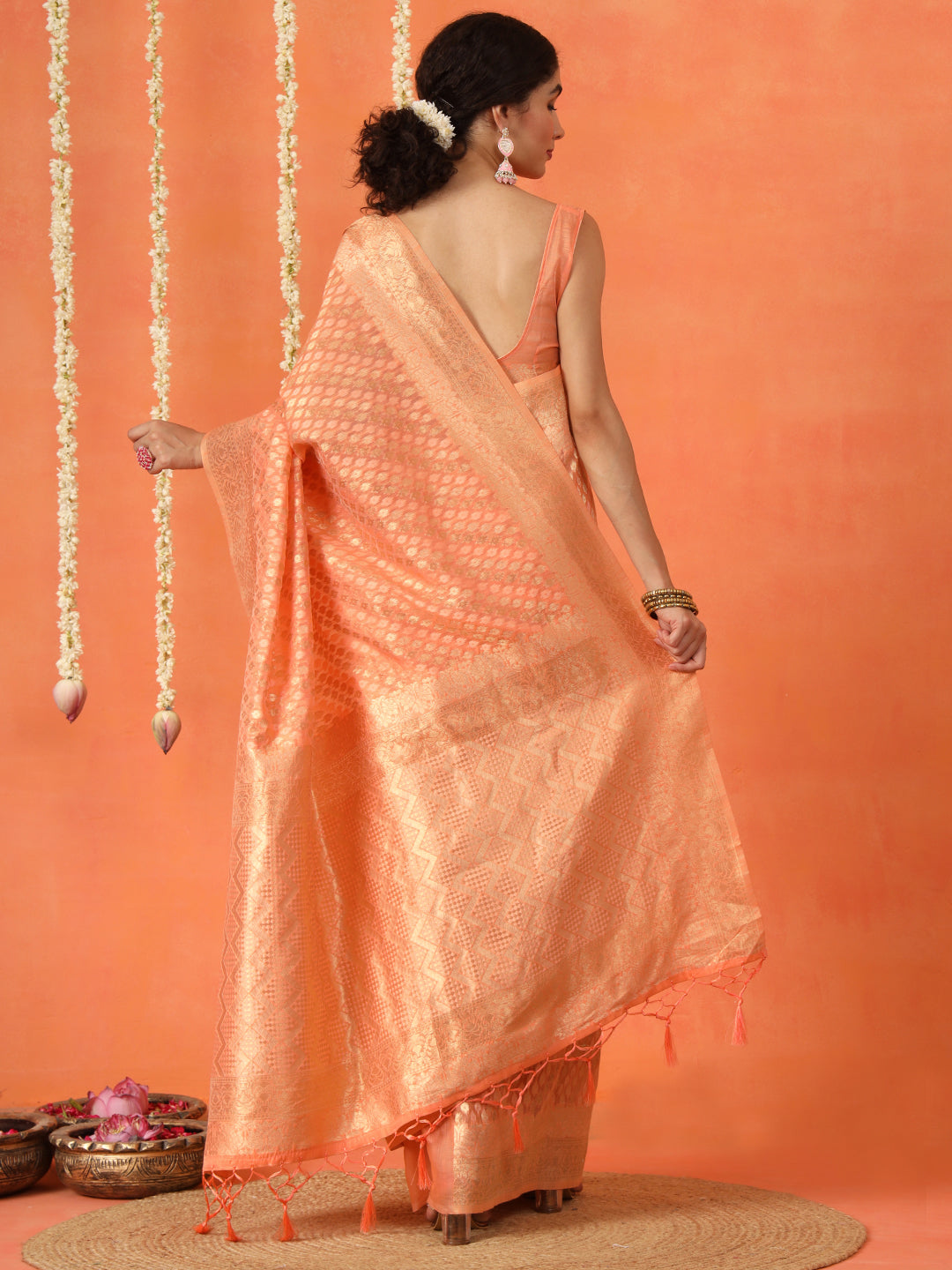 Peach colored poly cotton woven designer saree with tassles on pallu