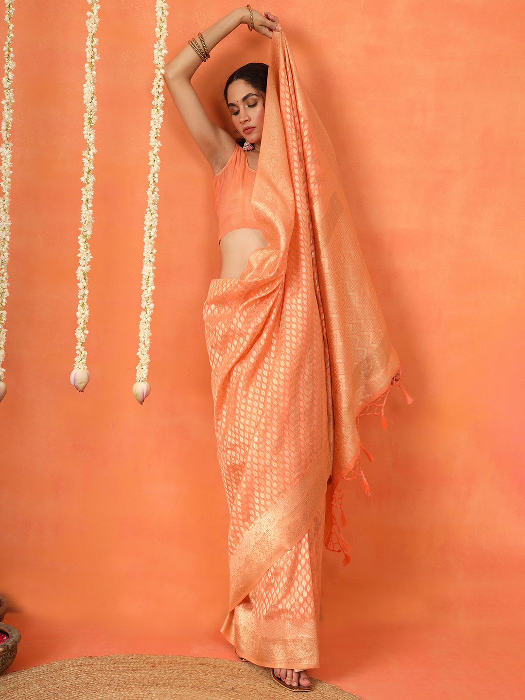 Peach colored poly cotton woven designer saree with tassles on pallu