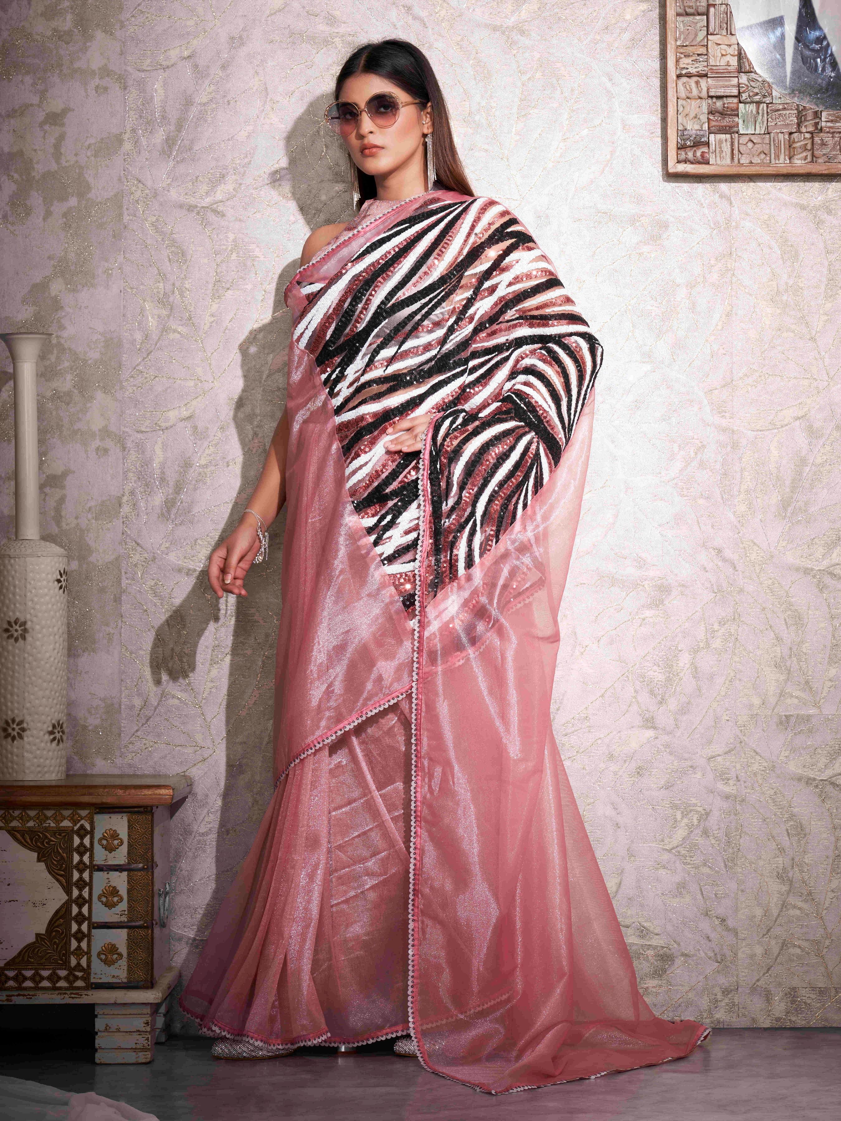 Pink colored shimmer net designer saree with sequence embroidery on shoulder and sequinned lace