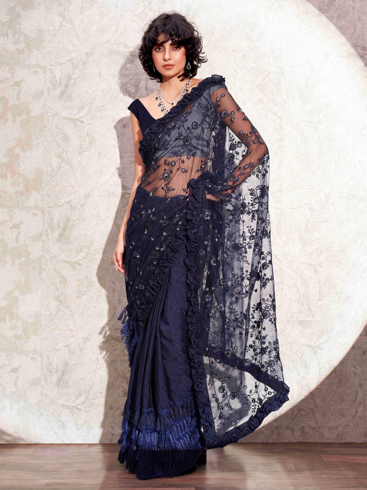 Blue colored half and half net and jacquard saree with embroidered pallu frill and tassles in patli