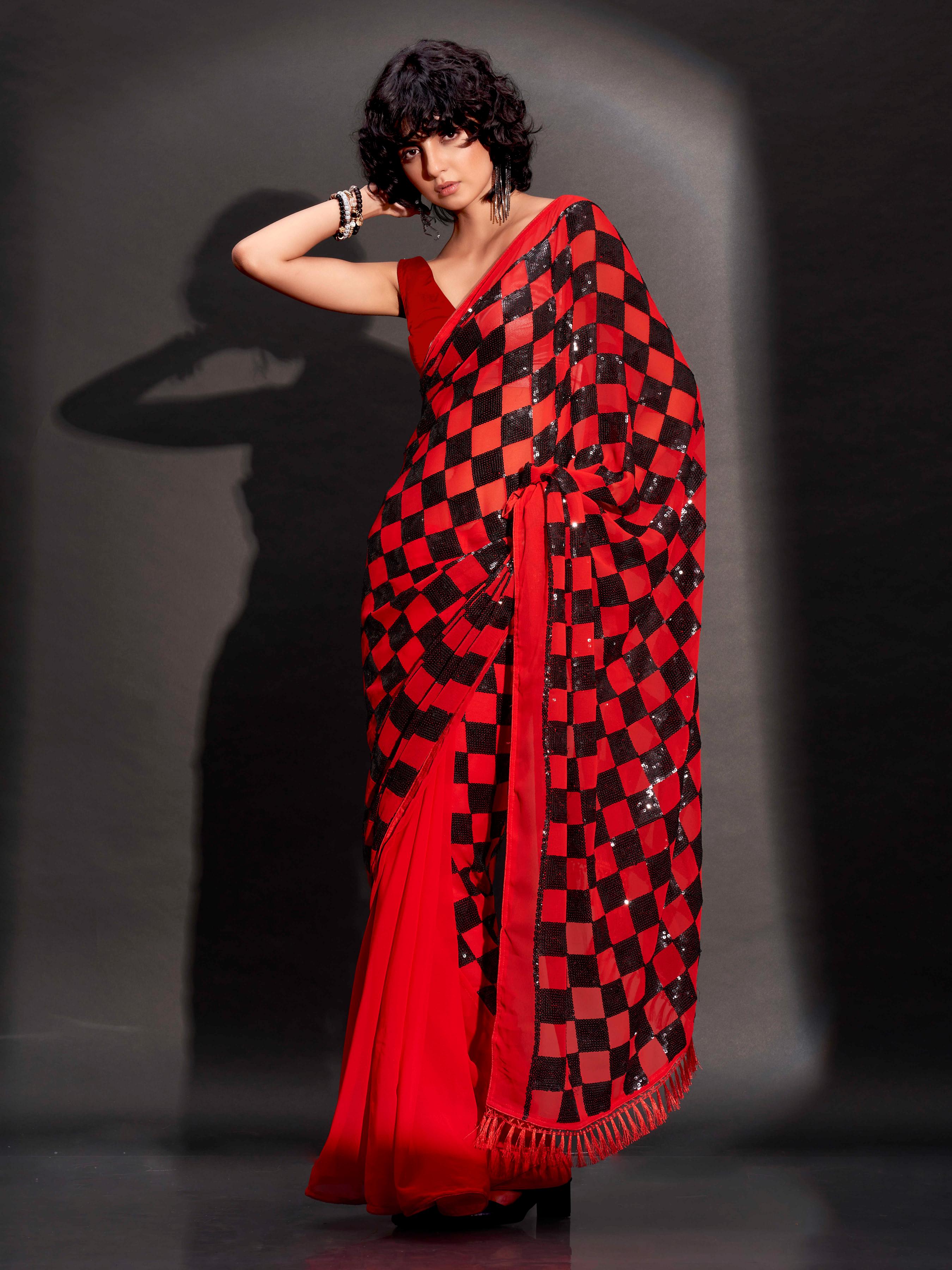 Two way wearbable red sequinned georgette saree with tassles on pallu