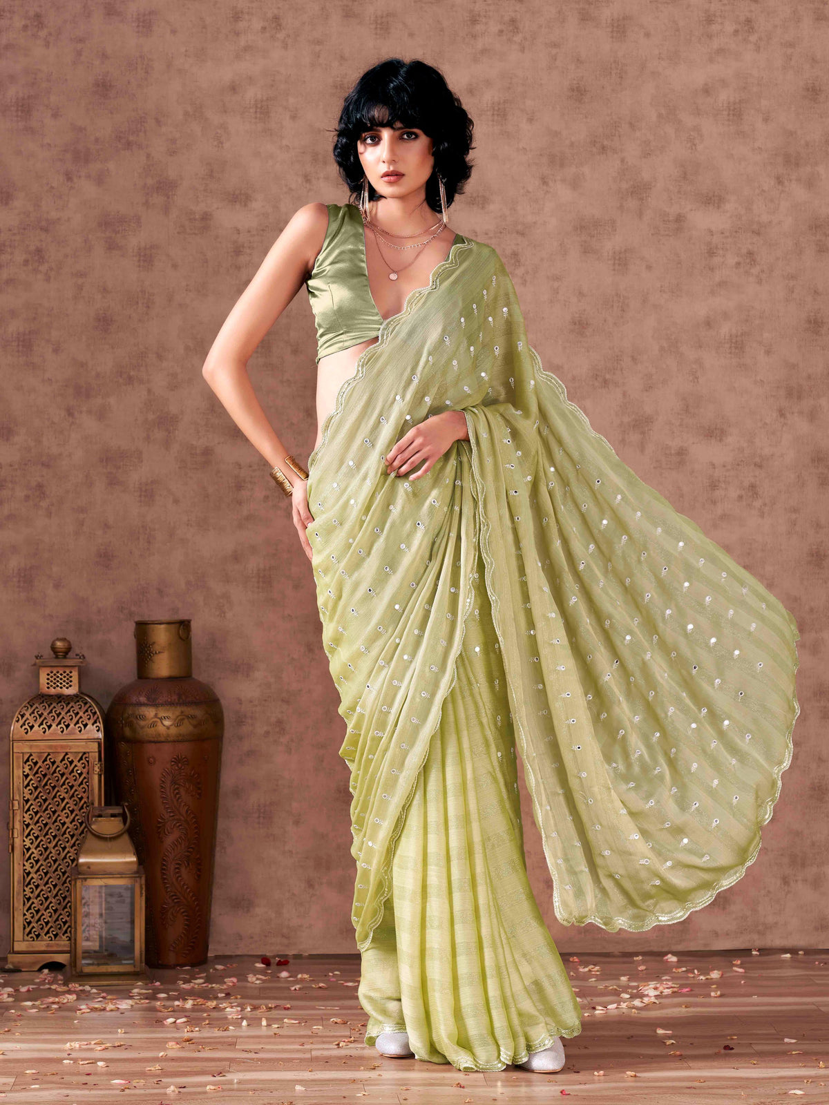 Pista green colored striped satin chiffon saree with mirror embroidery on pallu and scalloped border