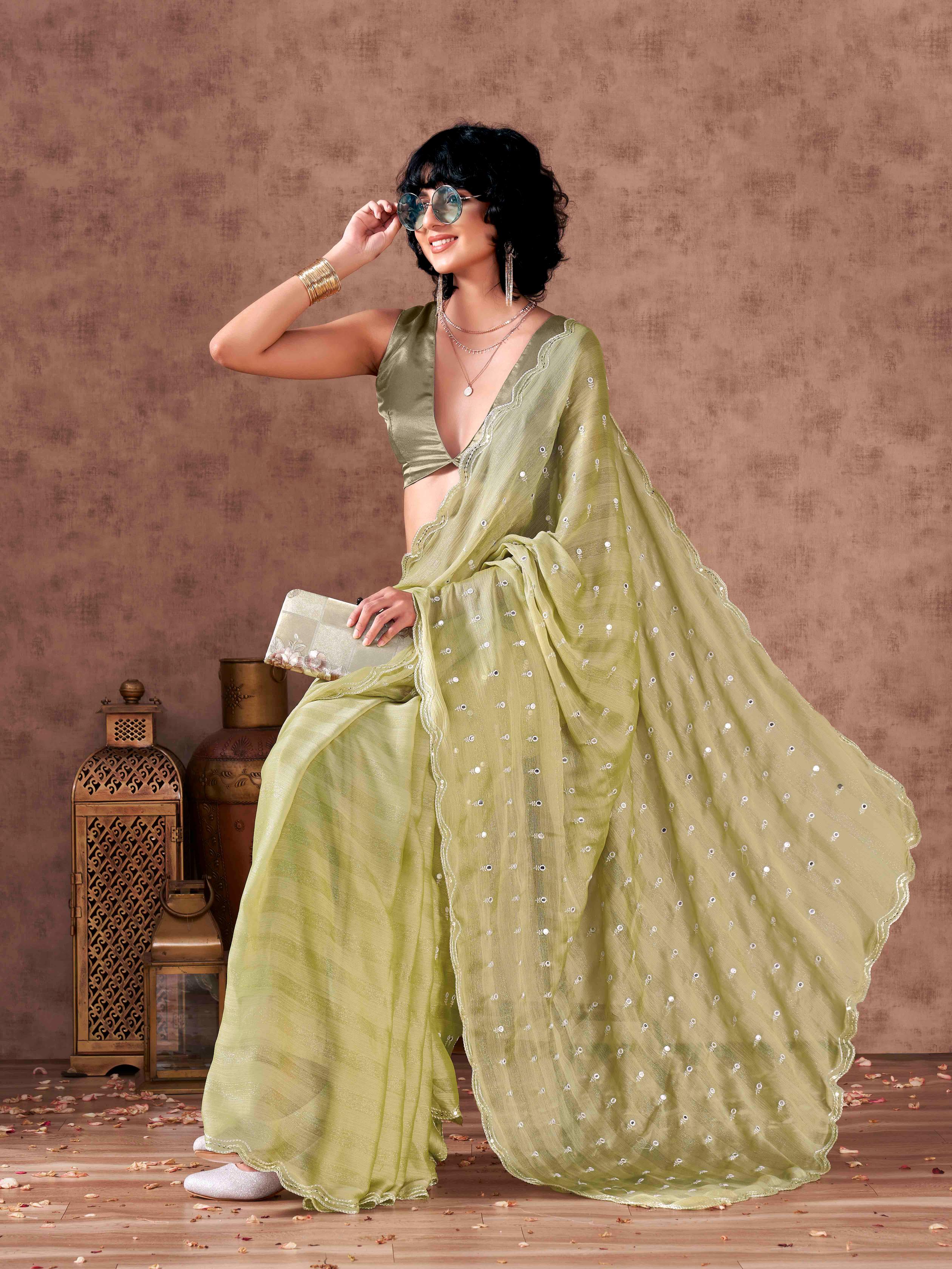 Pista green colored striped satin chiffon saree with mirror embroidery on pallu and scalloped border