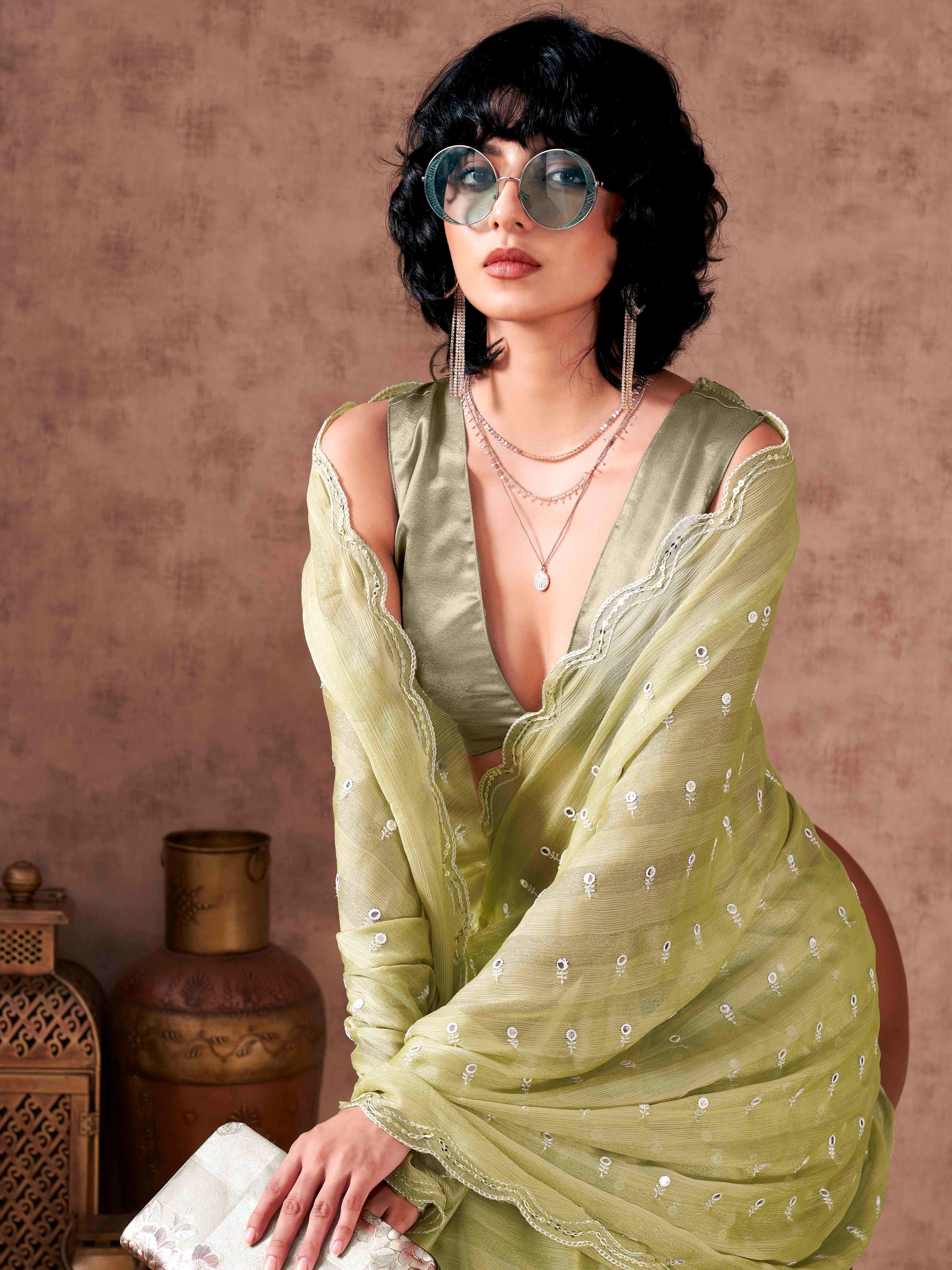 Pista green colored striped satin chiffon saree with mirror embroidery on pallu and scalloped border