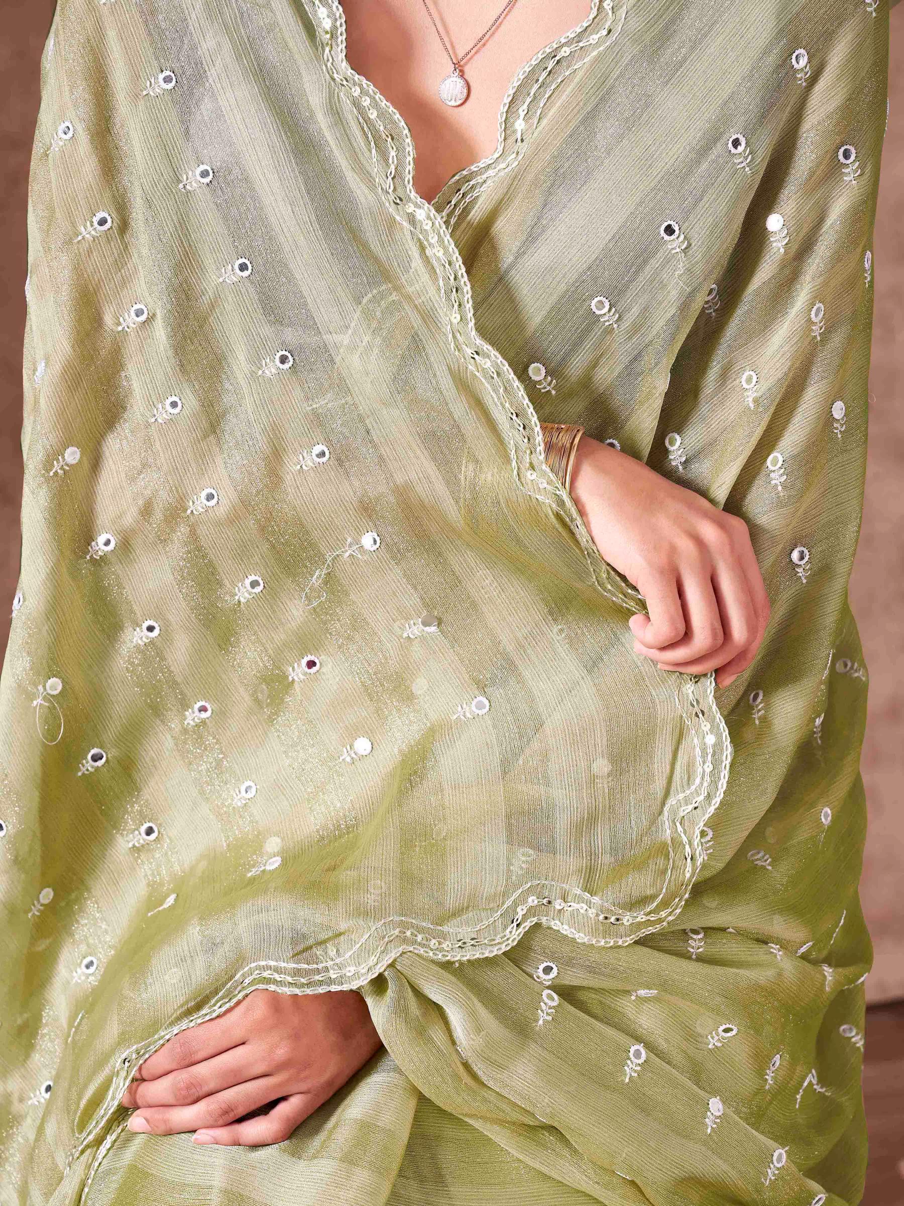 Pista green colored striped satin chiffon saree with mirror embroidery on pallu and scalloped border