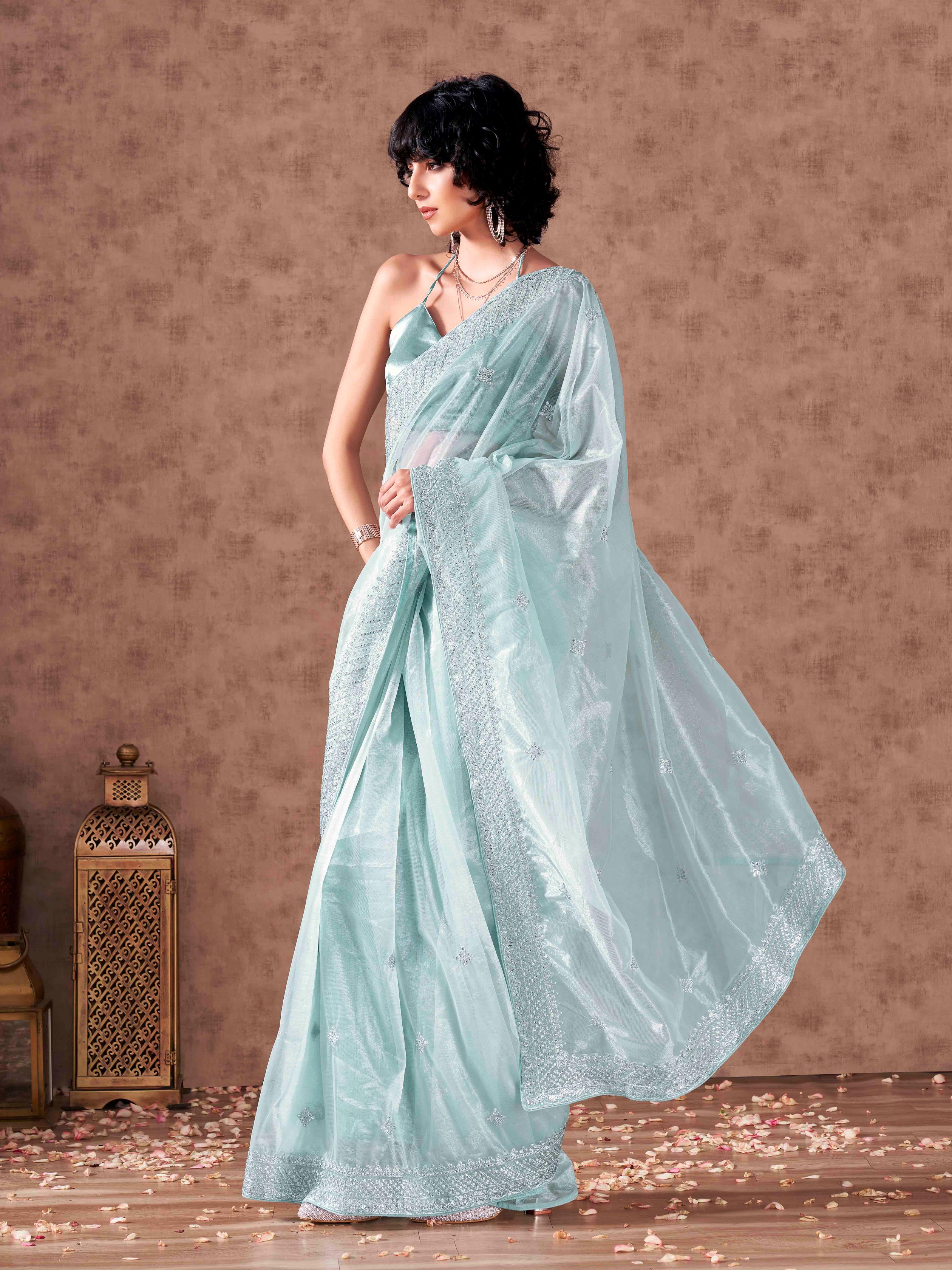 Sky blue colored shimmer net sequinned embroidered saree with embroidered blouse