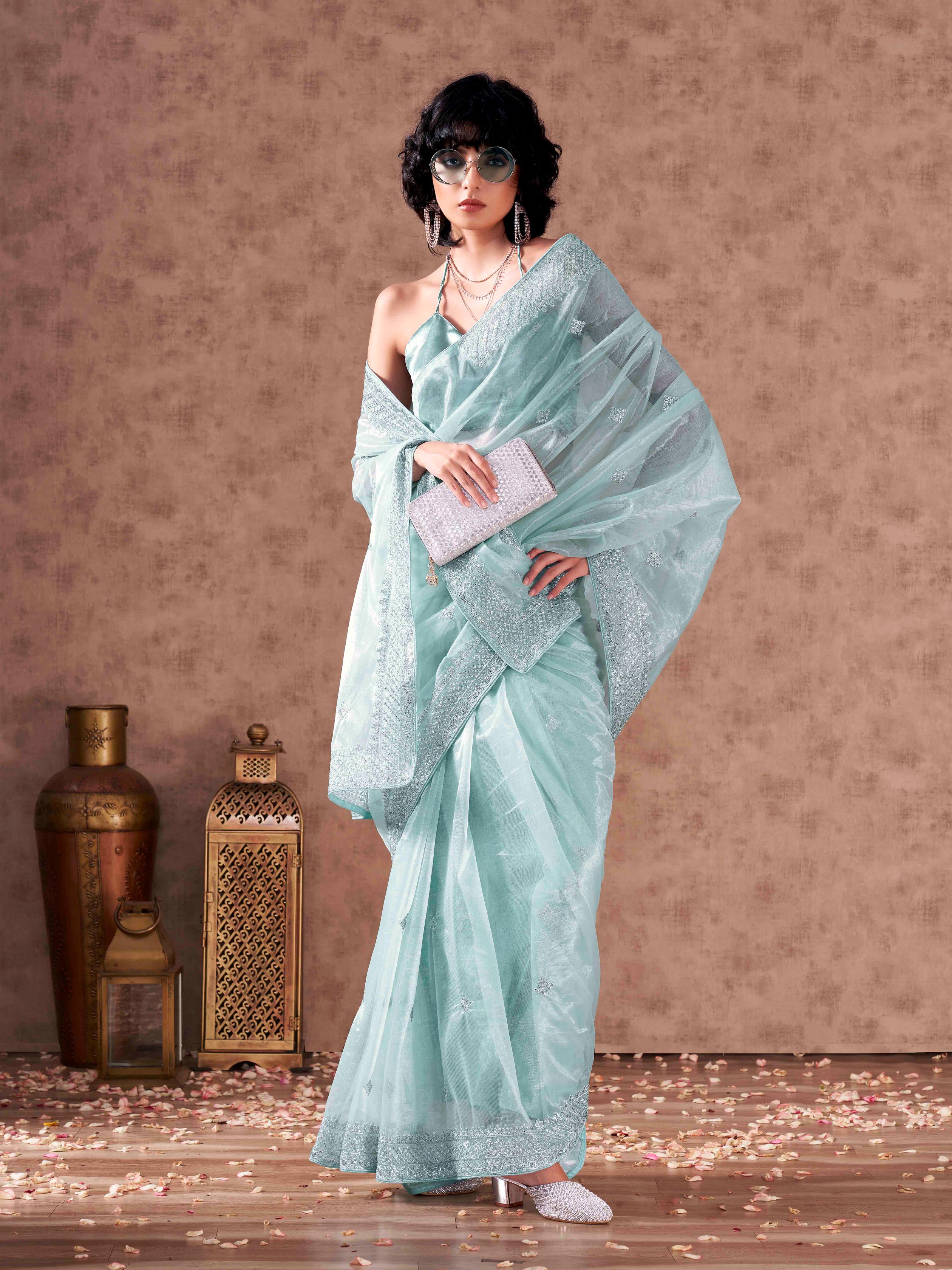 Sky blue colored shimmer net sequinned embroidered saree with embroidered blouse