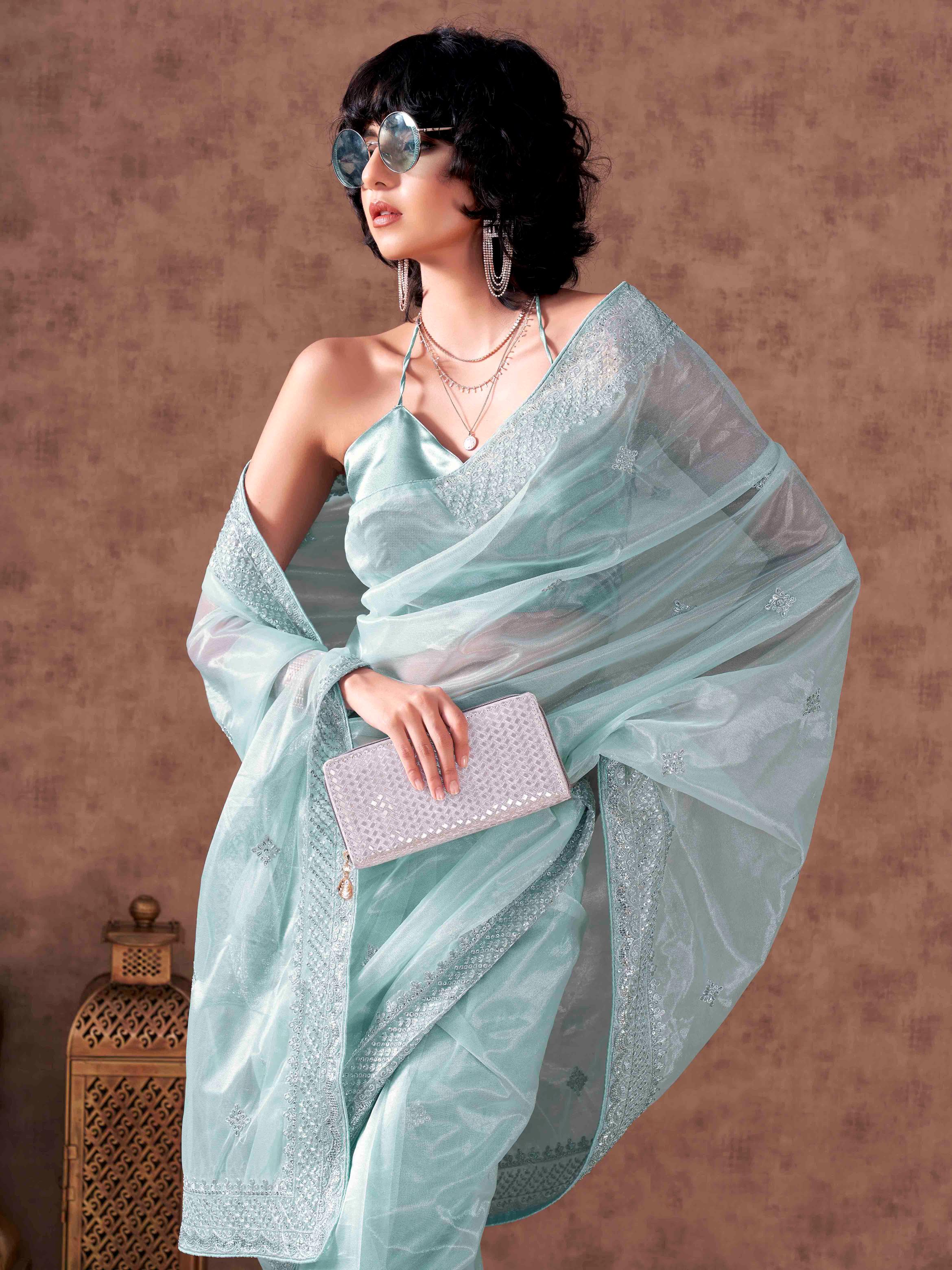 Sky blue colored shimmer net sequinned embroidered saree with embroidered blouse