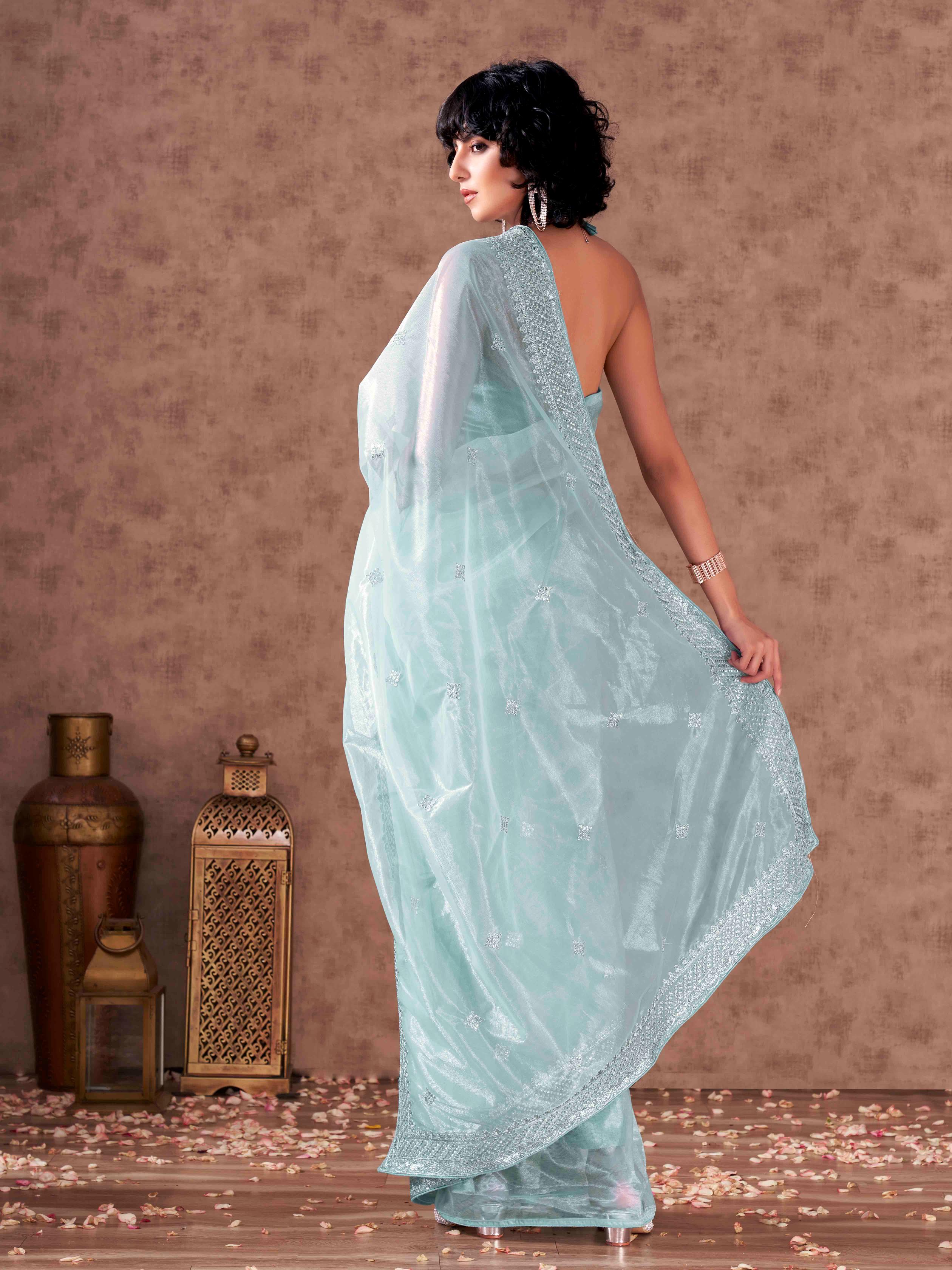 Sky blue colored shimmer net sequinned embroidered saree with embroidered blouse