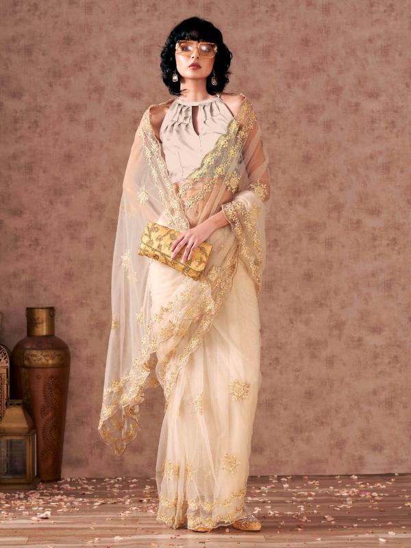 Cream colored net saree with thread work scalloped border and faux diamonds