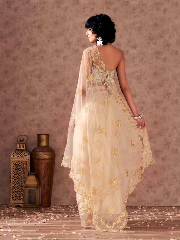 Cream colored net saree with thread work scalloped border and faux diamonds