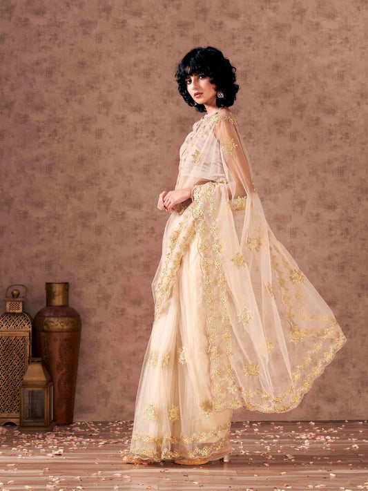 Cream colored net saree with thread work scalloped border and faux diamonds