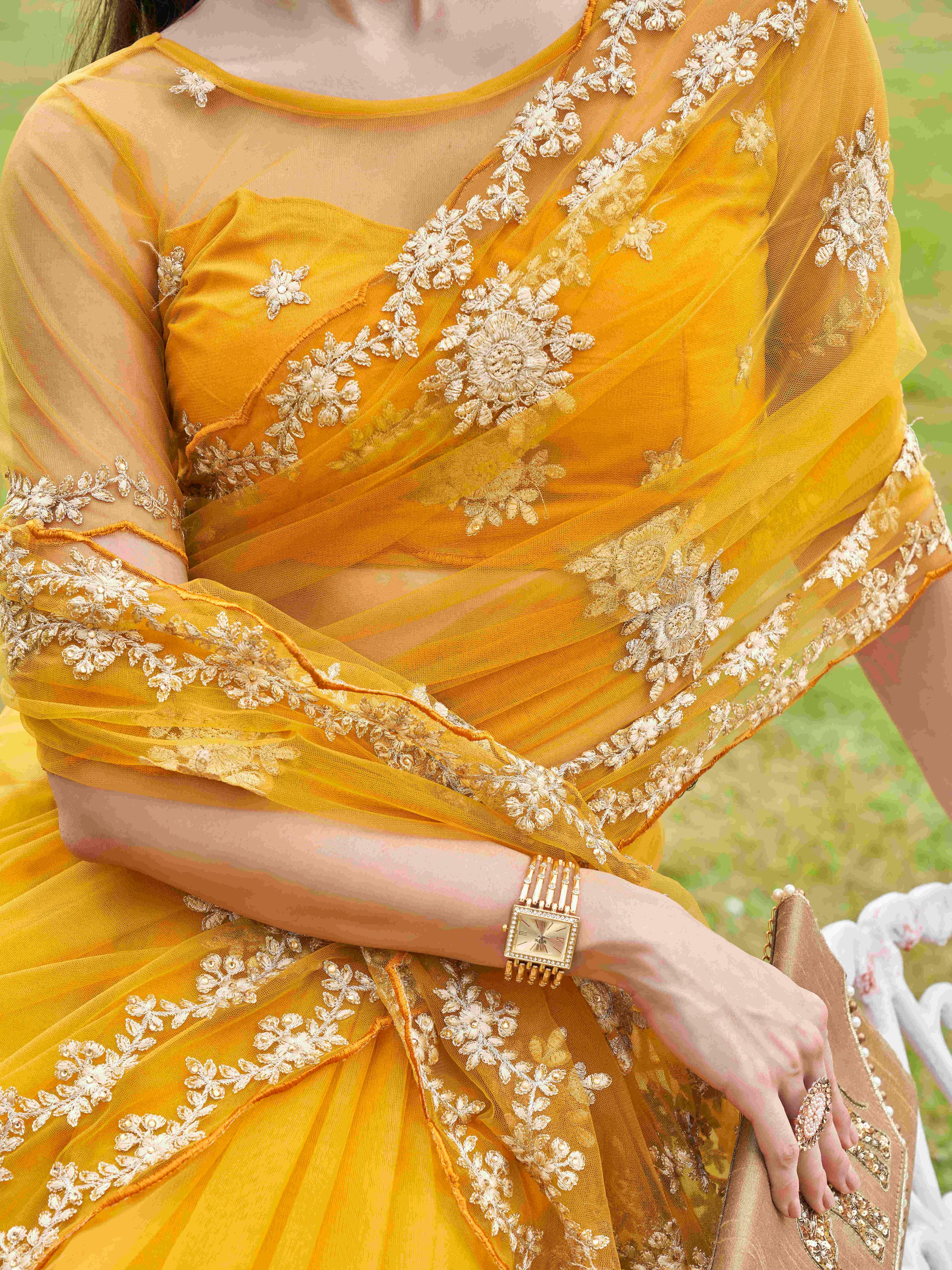 Mustard colored net saree with thread work scalloped border and faux diamonds