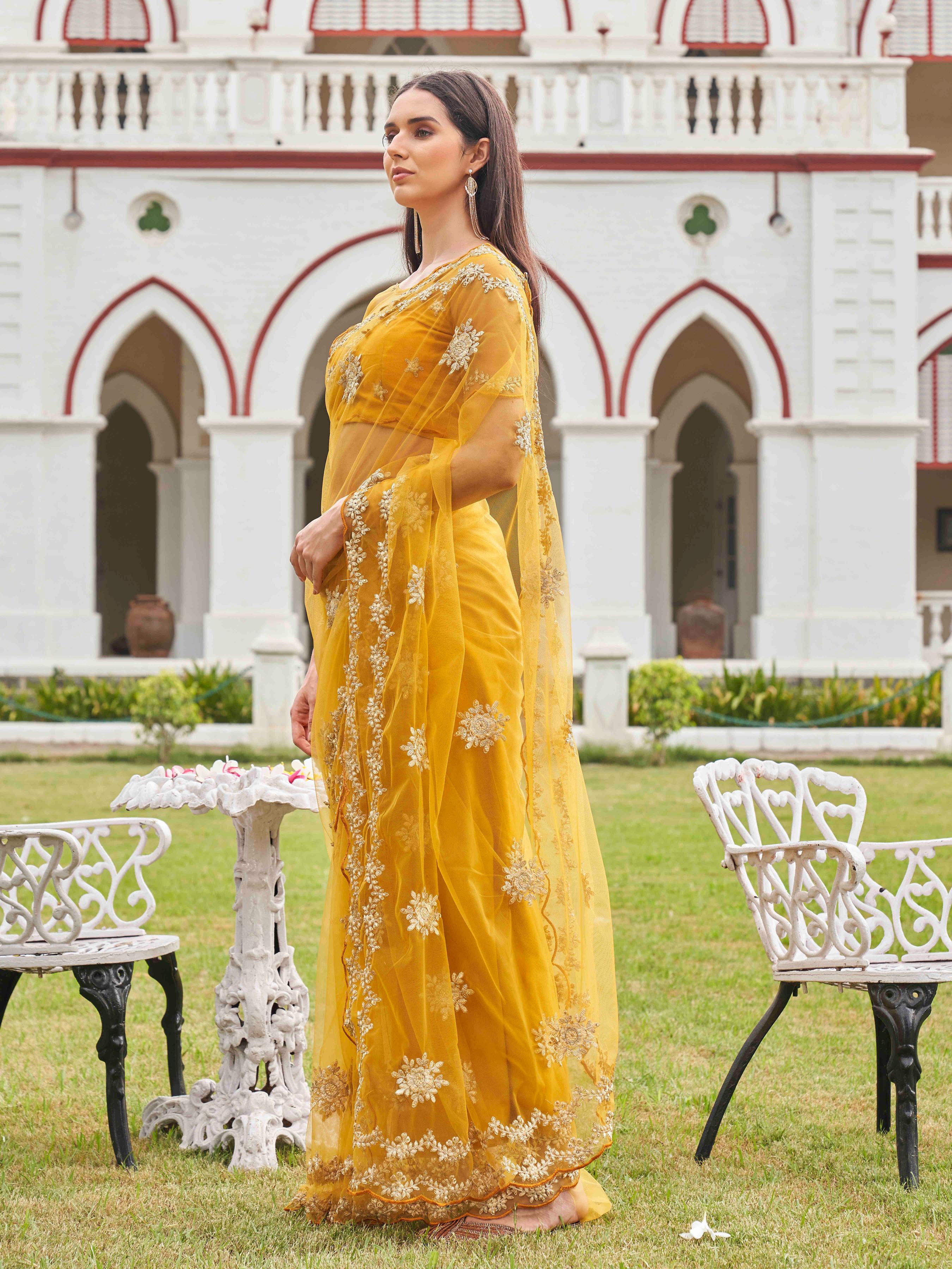 Mustard colored net saree with thread work scalloped border and faux diamonds