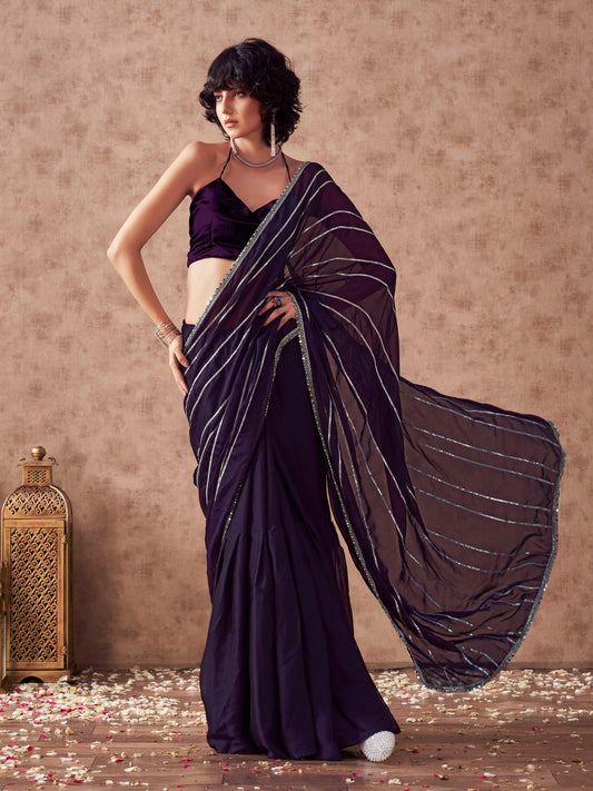 Violet colored satin saree with gota patti lining on pallu and frill on patli