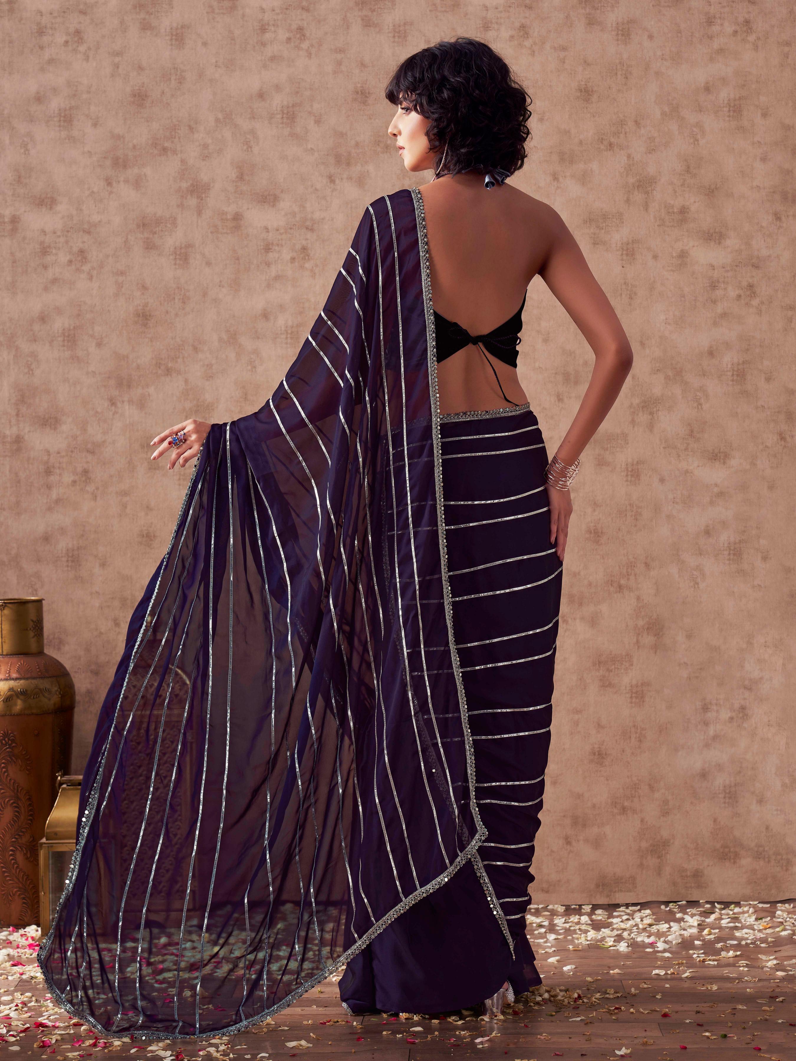 Violet colored satin saree with gota patti lining on pallu and frill on patli