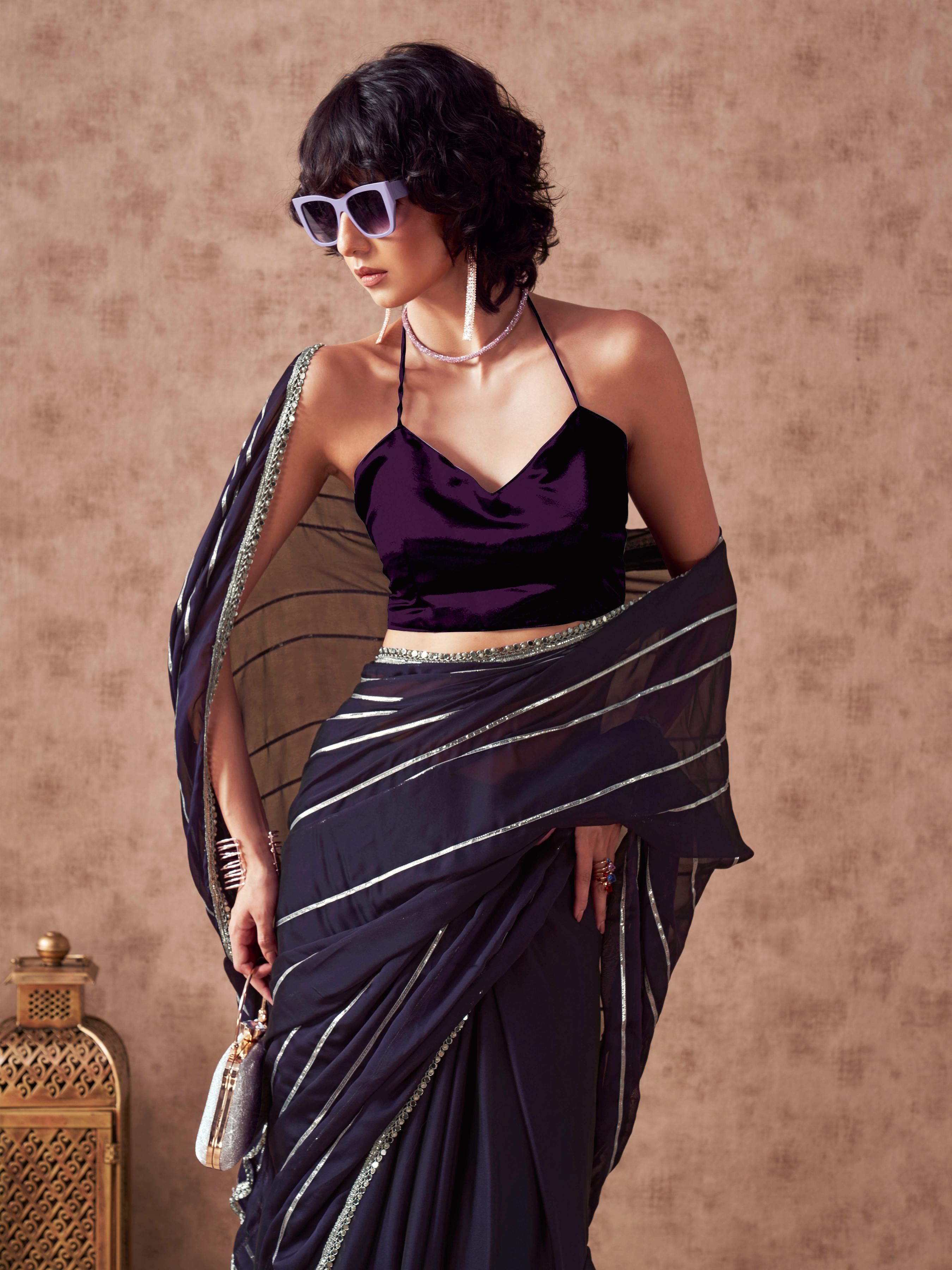 Violet colored satin saree with gota patti lining on pallu and frill on patli