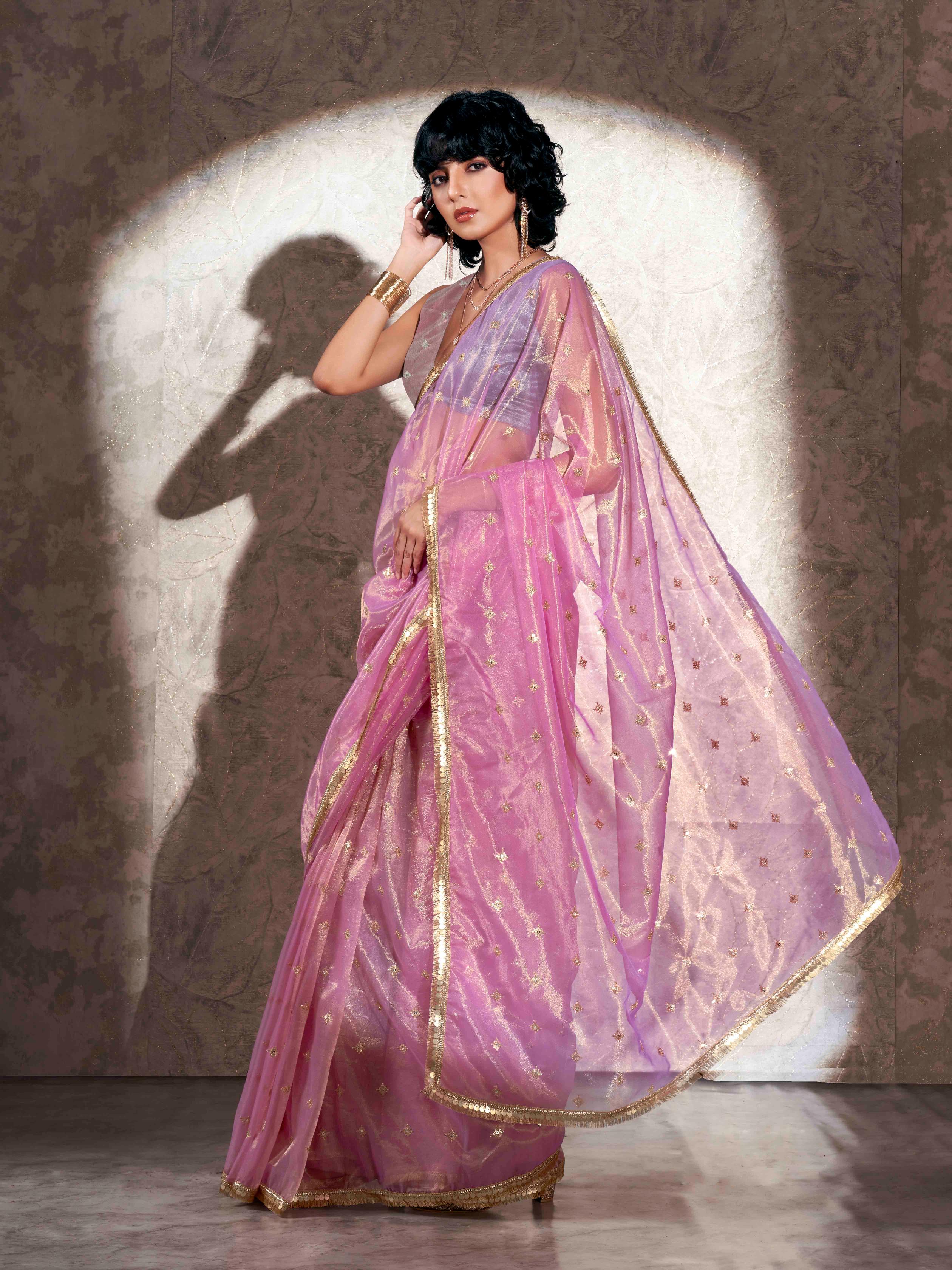 Pink colored shimmer net saree with sequence embroidery and sequinned tassle lace