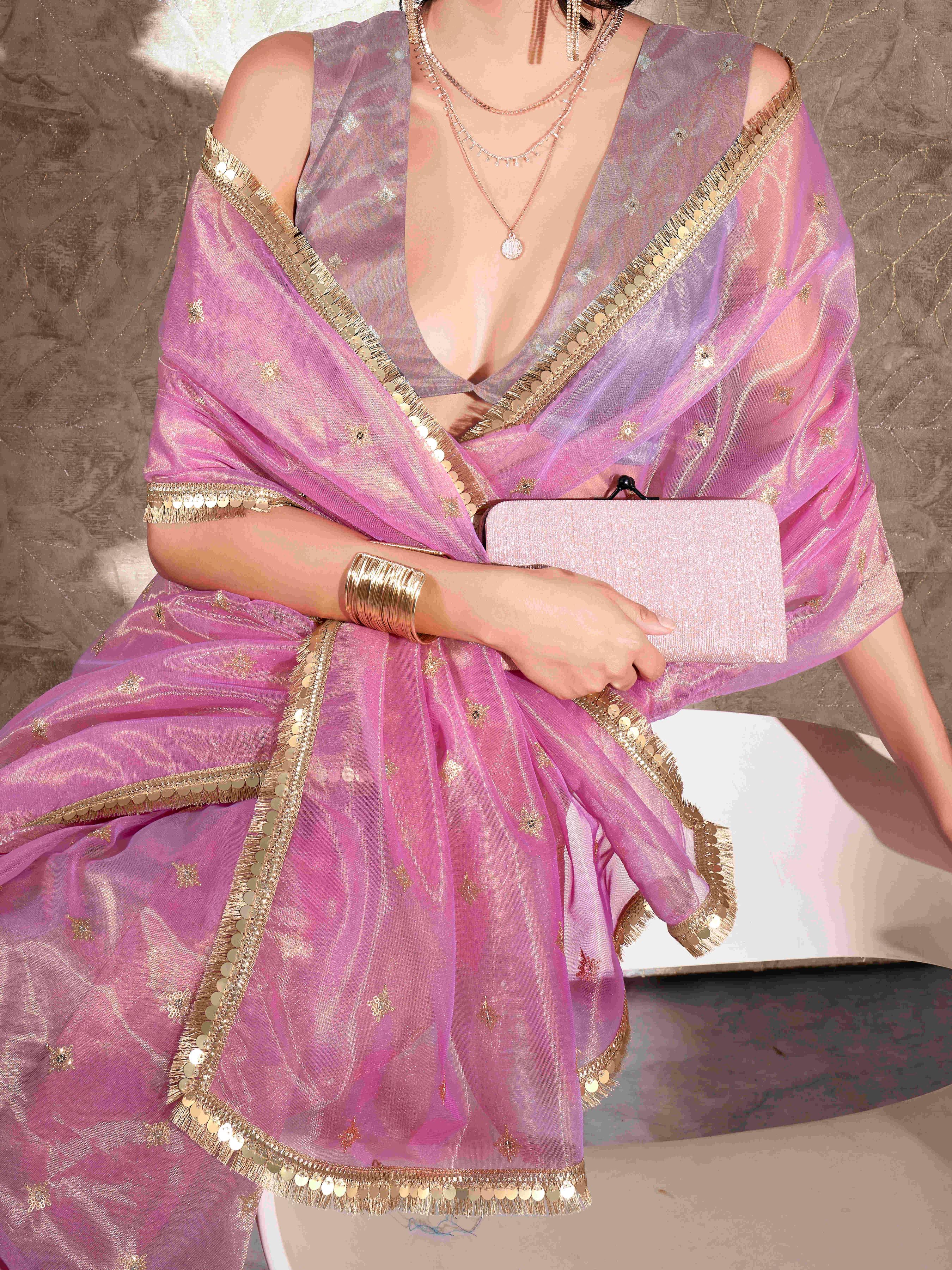 Pink colored shimmer net saree with sequence embroidery and sequinned tassle lace