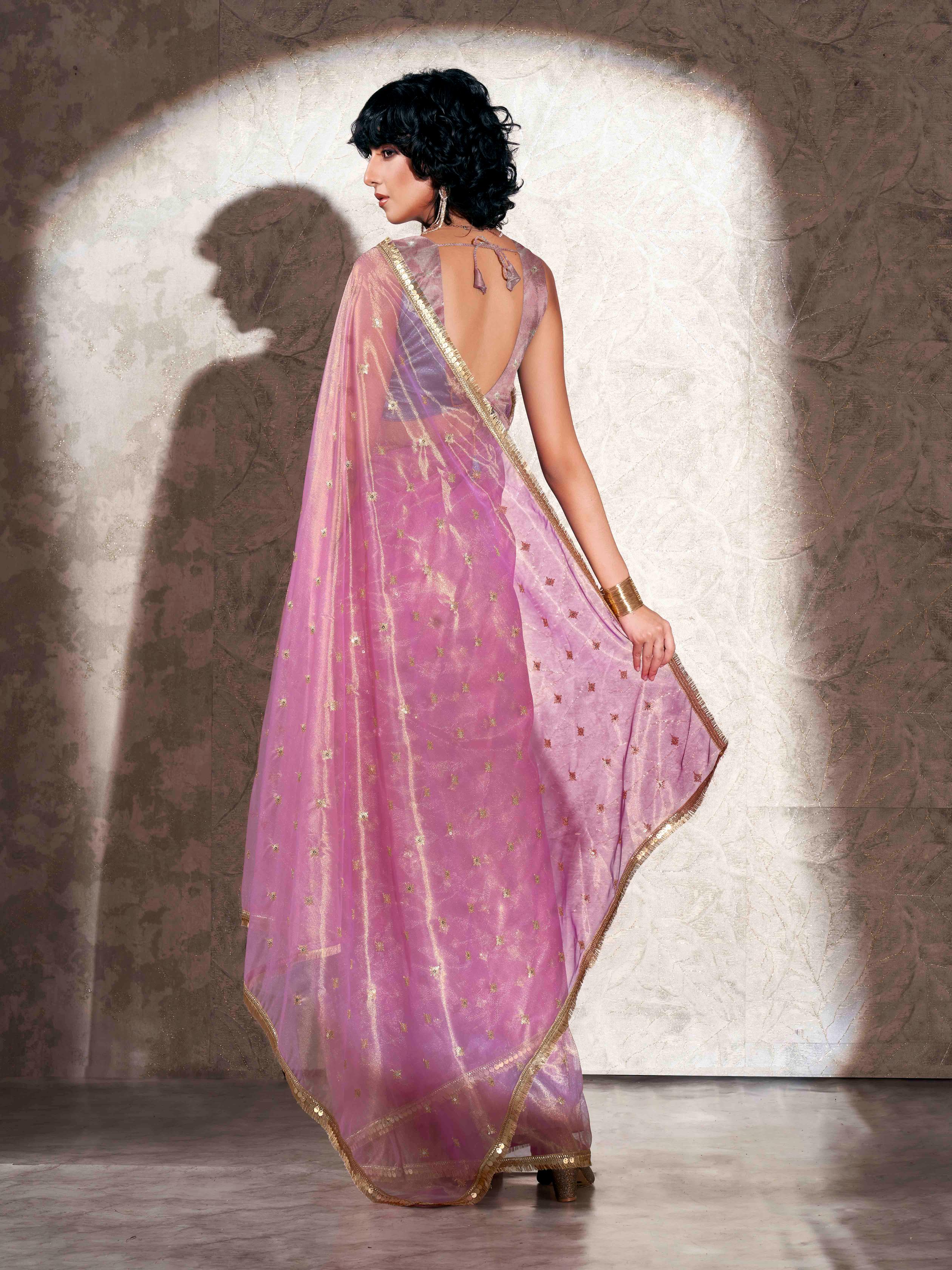 Pink colored shimmer net saree with sequence embroidery and sequinned tassle lace