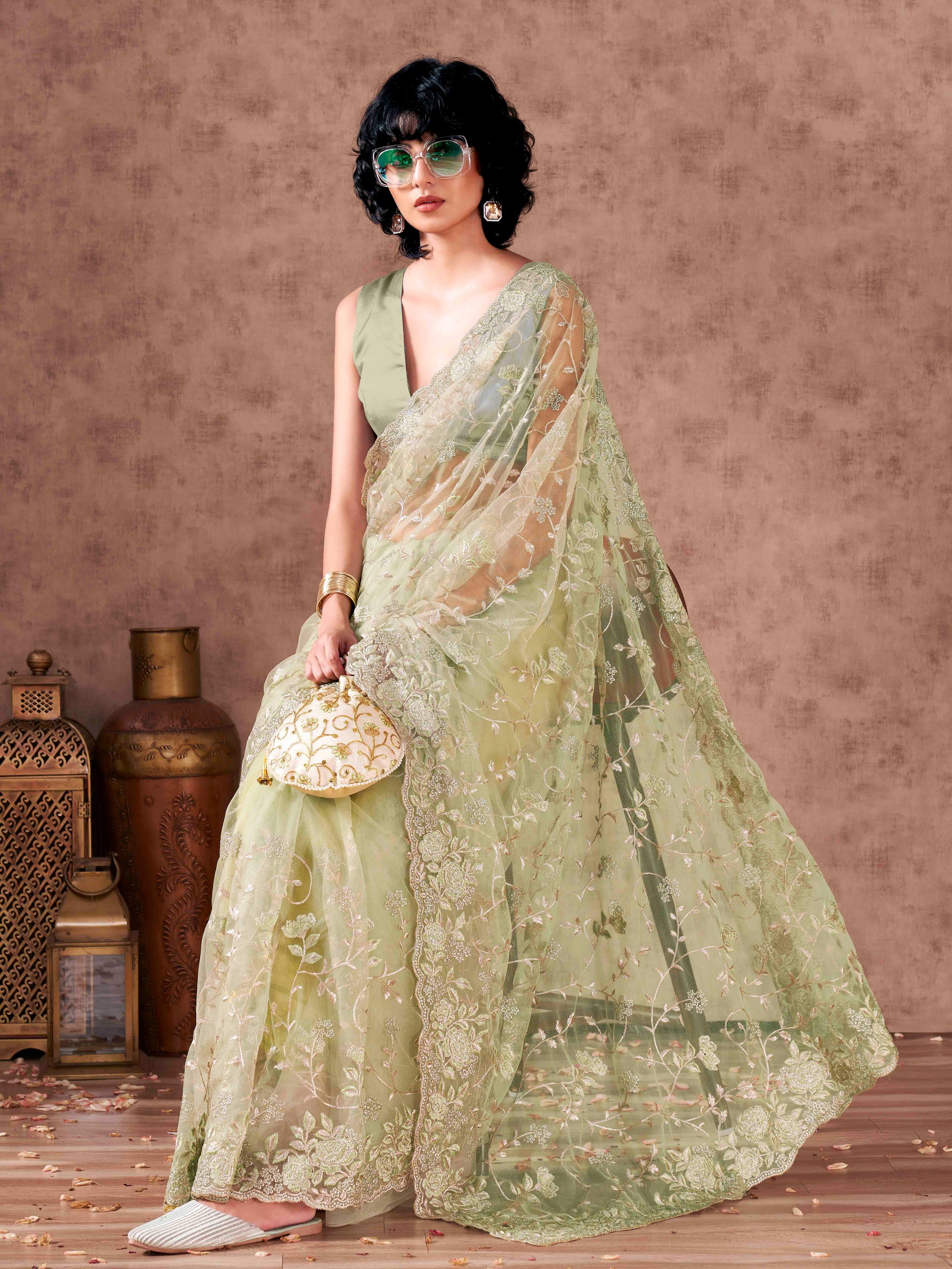 Green colored embroidered net saree  with scalloped border