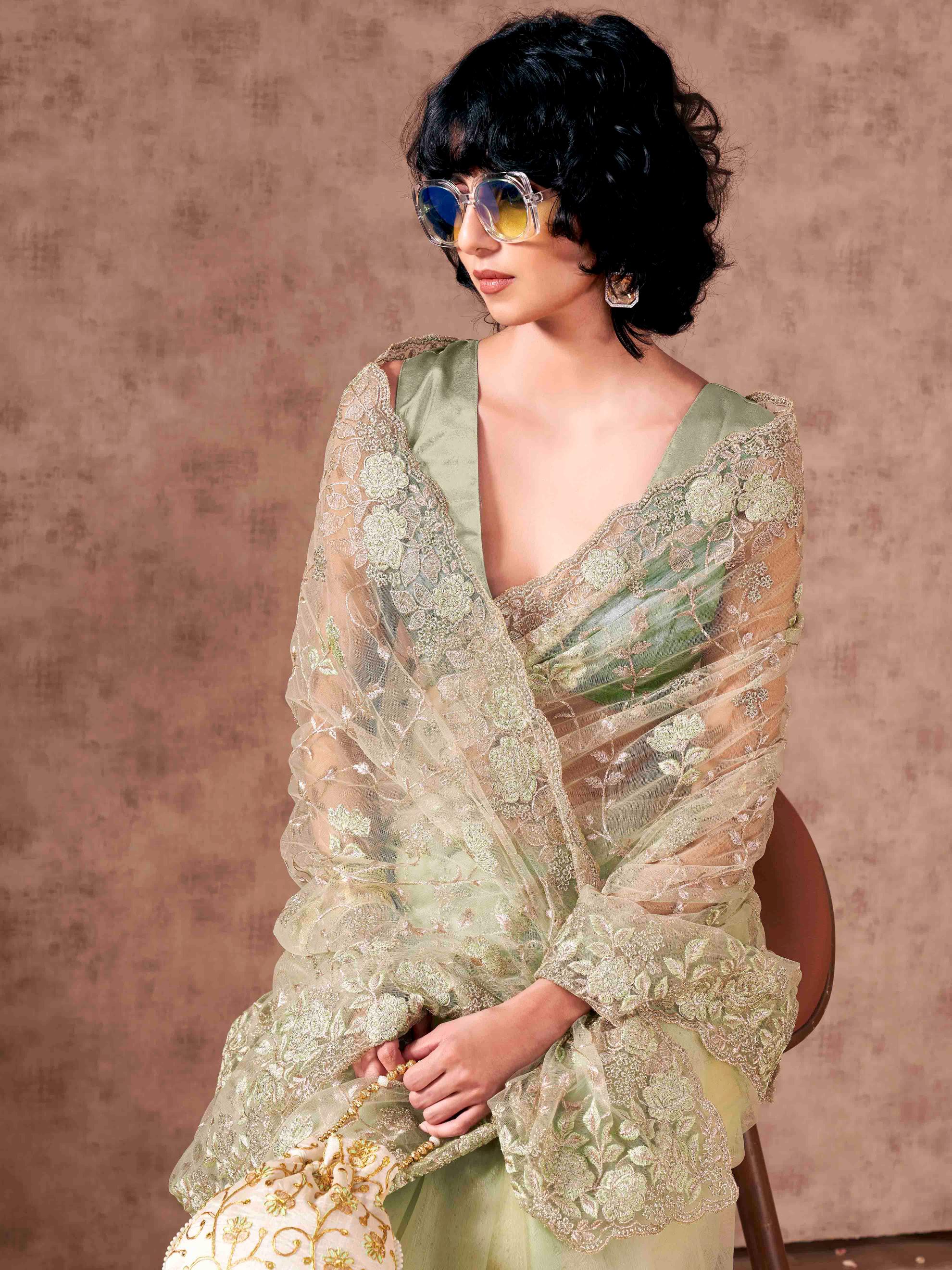 Green colored embroidered net saree  with scalloped border