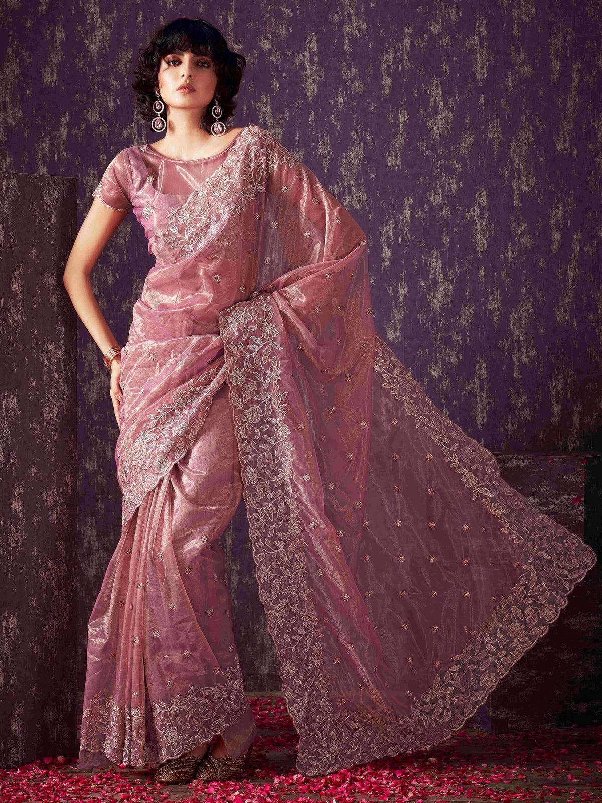 Pink colored shimmer net saree with jari embroidery scalloped border and faux diamonds