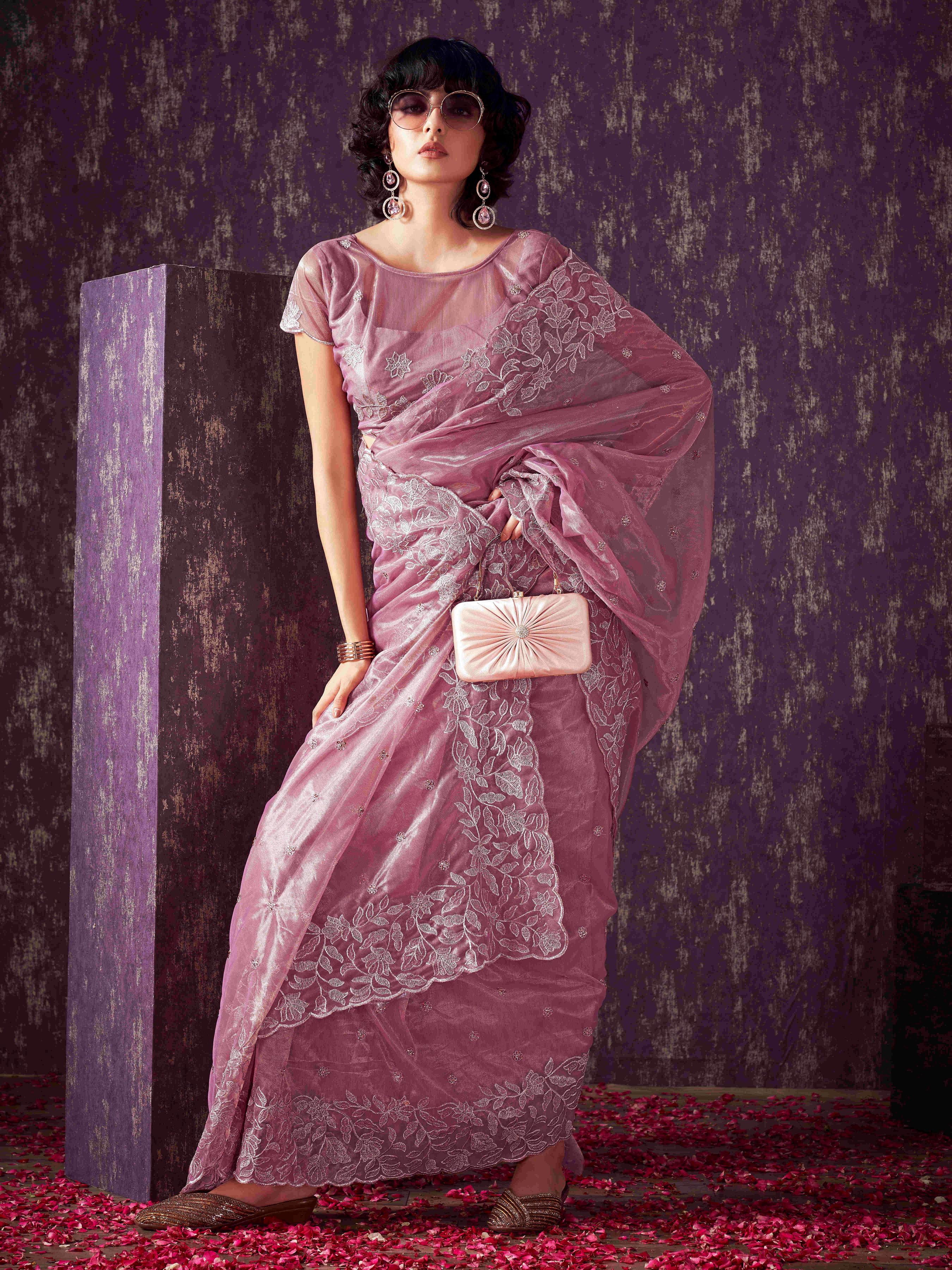 Pink colored shimmer net saree with jari embroidery scalloped border and faux diamonds