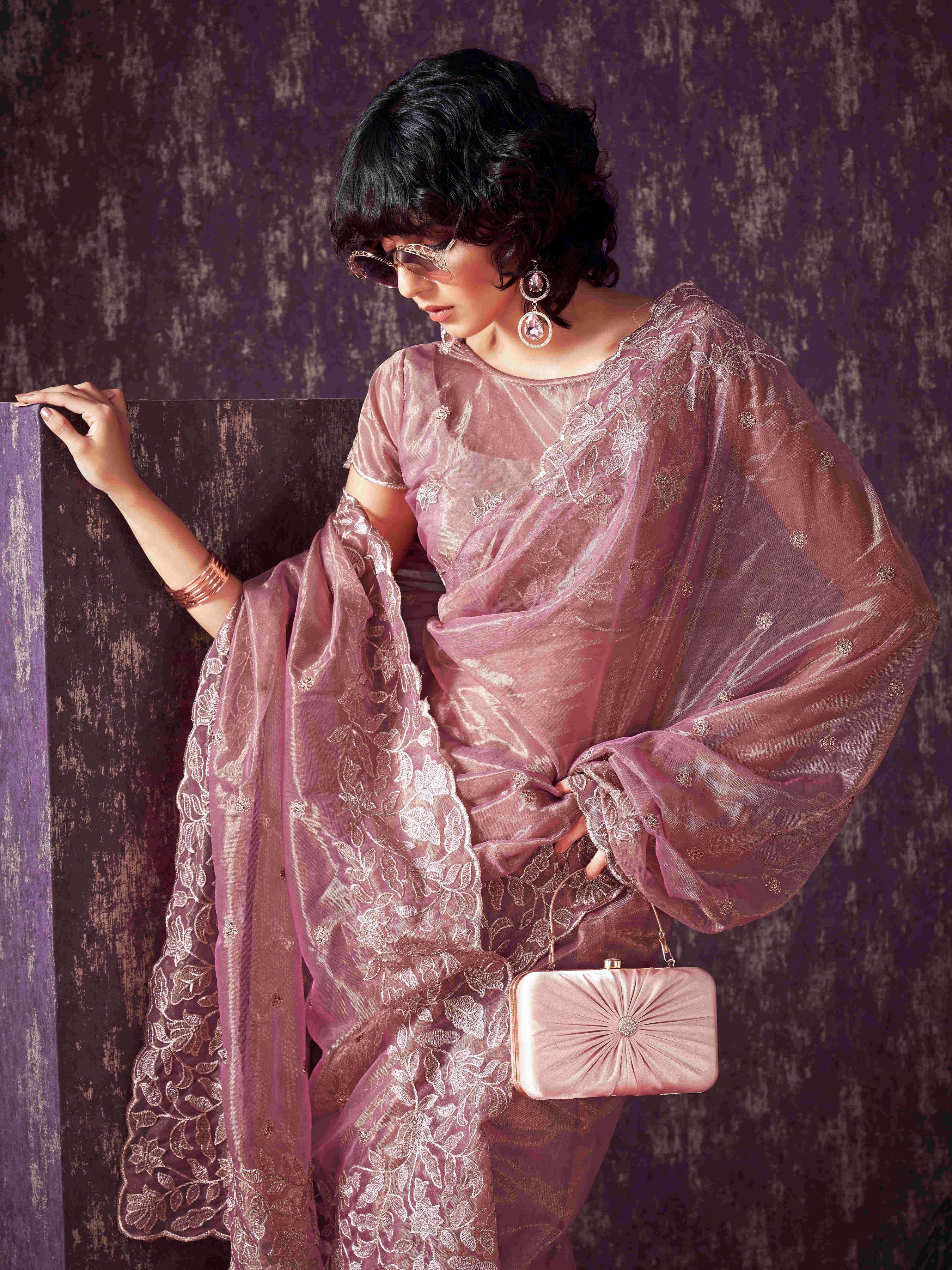 Pink colored shimmer net saree with jari embroidery scalloped border and faux diamonds