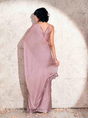 Pink colored satin chiffon saree with tassles and satin printed pleated blouse