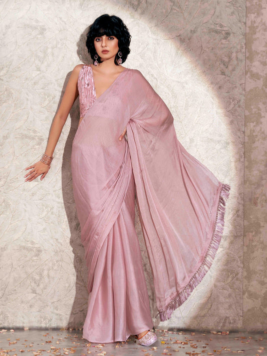 Pink colored satin chiffon saree with tassles and satin printed pleated blouse