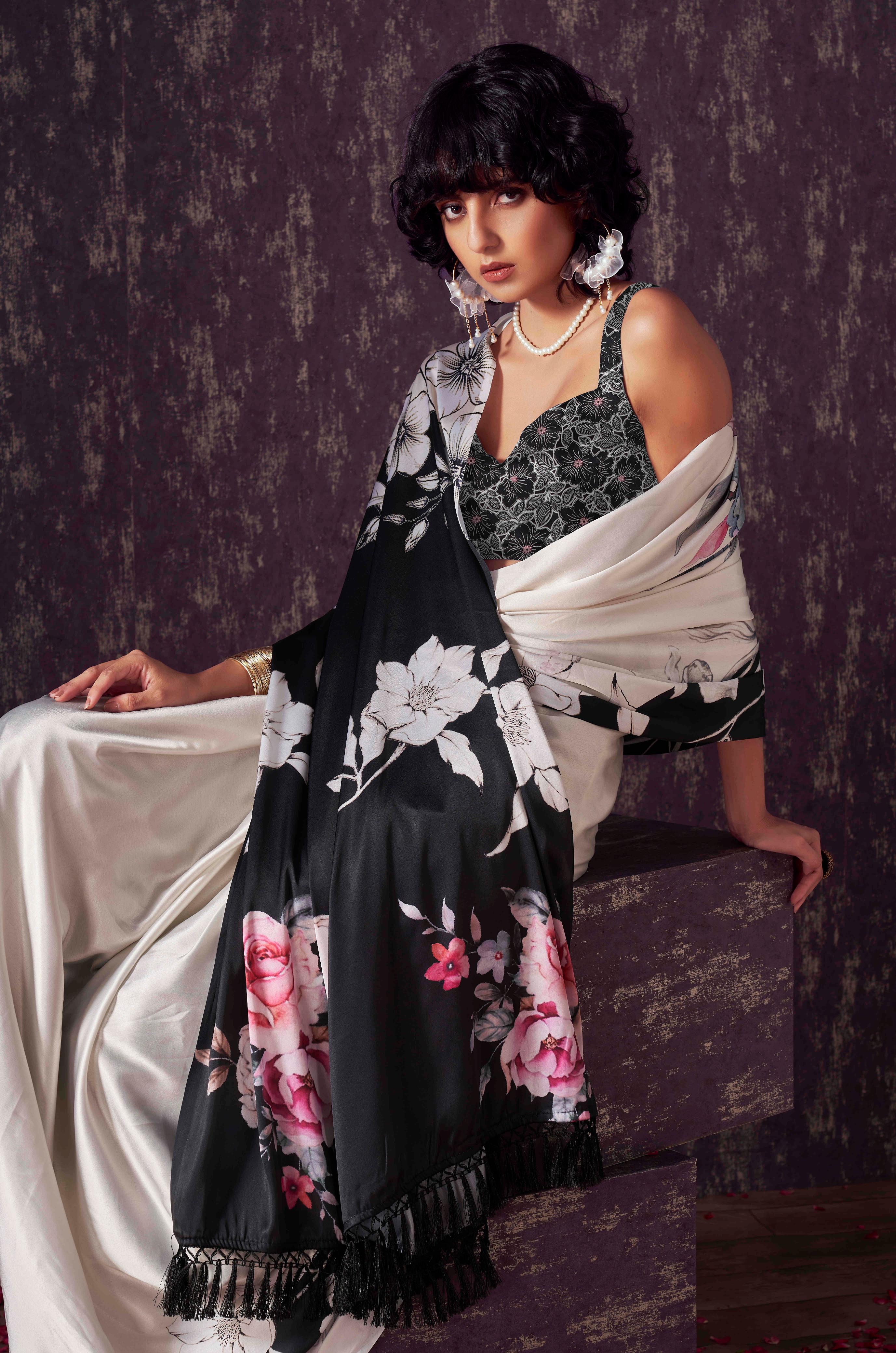 Two ways wearable cream and black colored digital printed floral satin saree with tassles