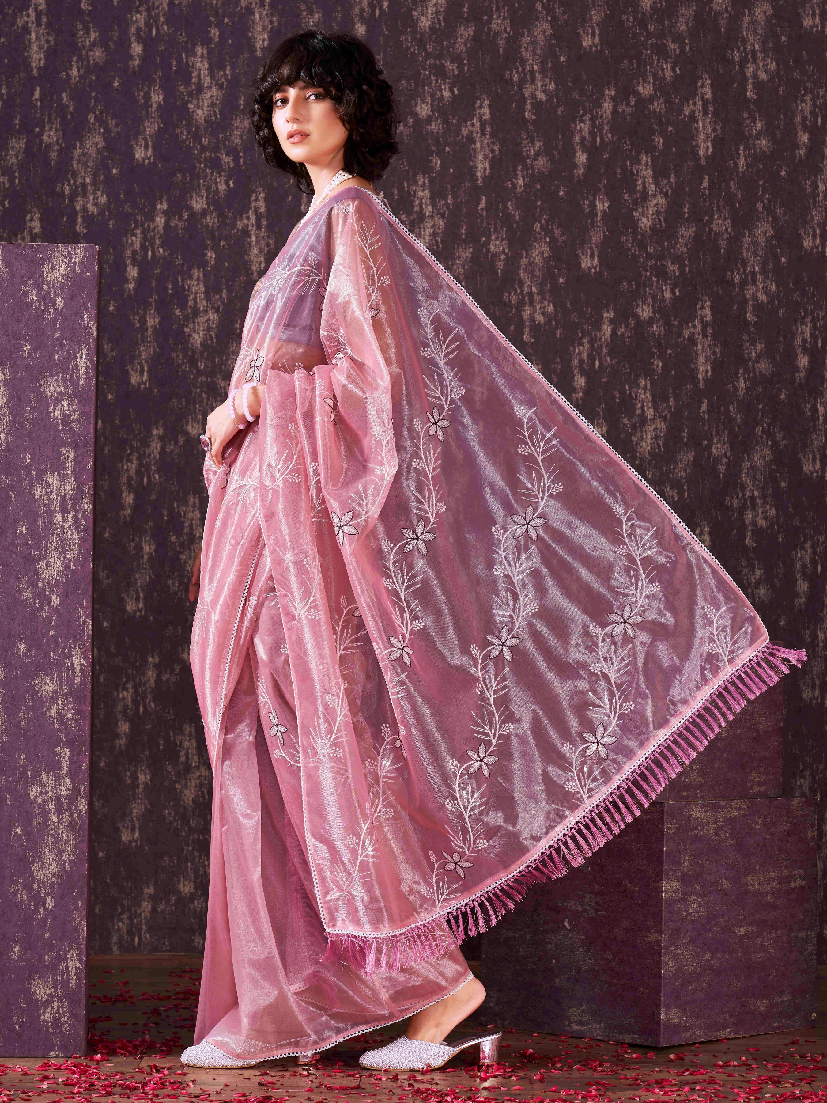 Pink colored half and half sequin embroidered net saree with embellished lace