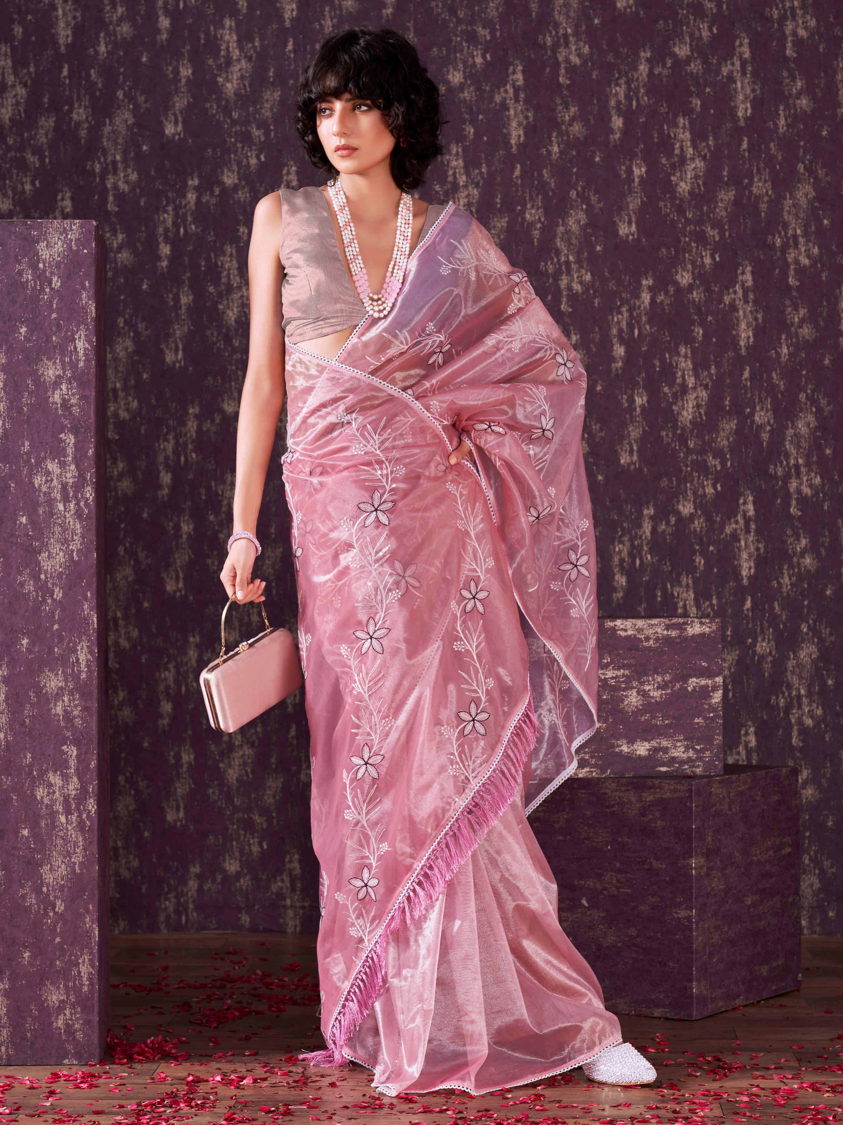 Pink colored half and half sequin embroidered net saree with embellished lace