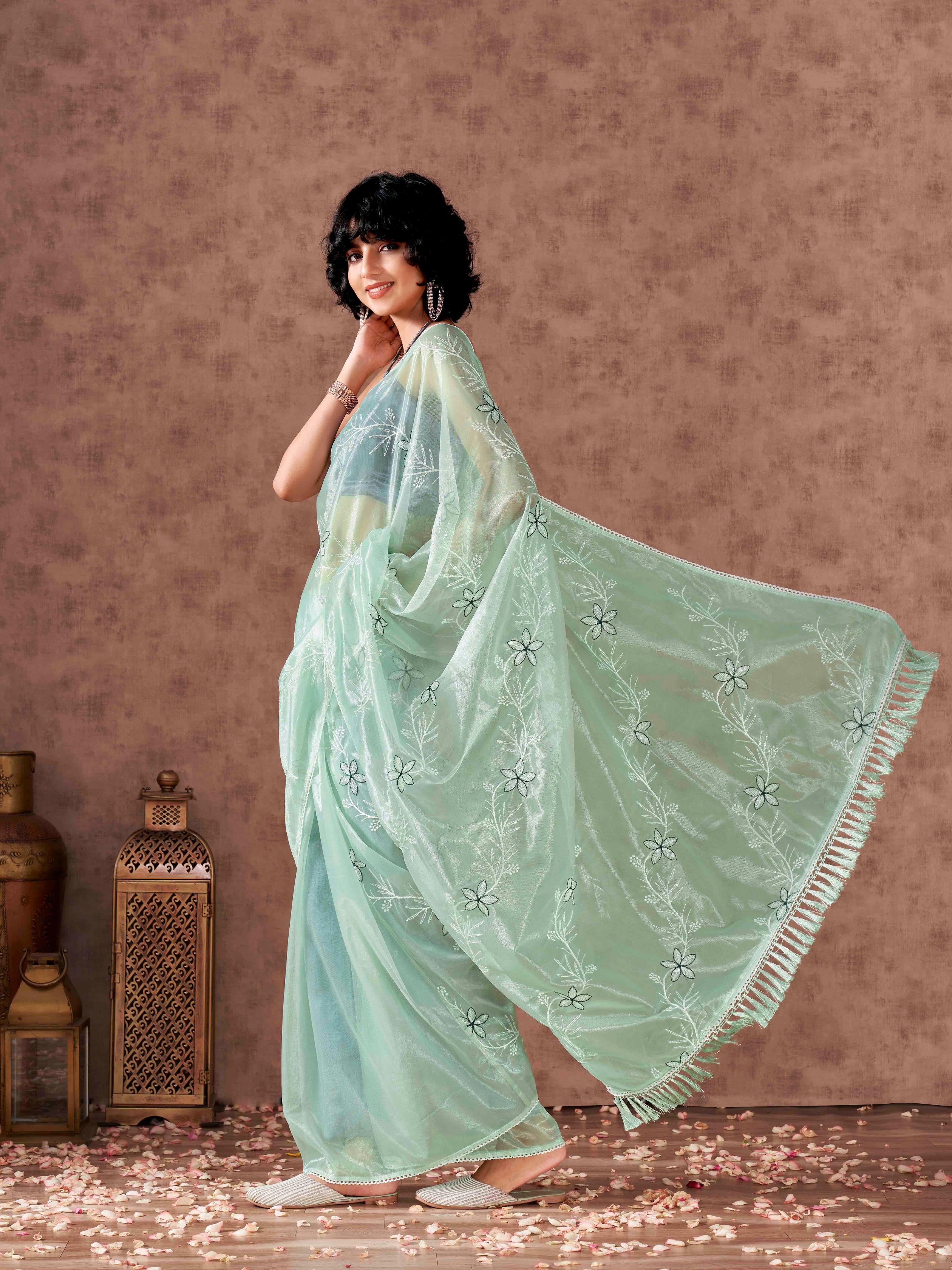 Sea Green colored half and half sequin embroidered net saree with embellished lace