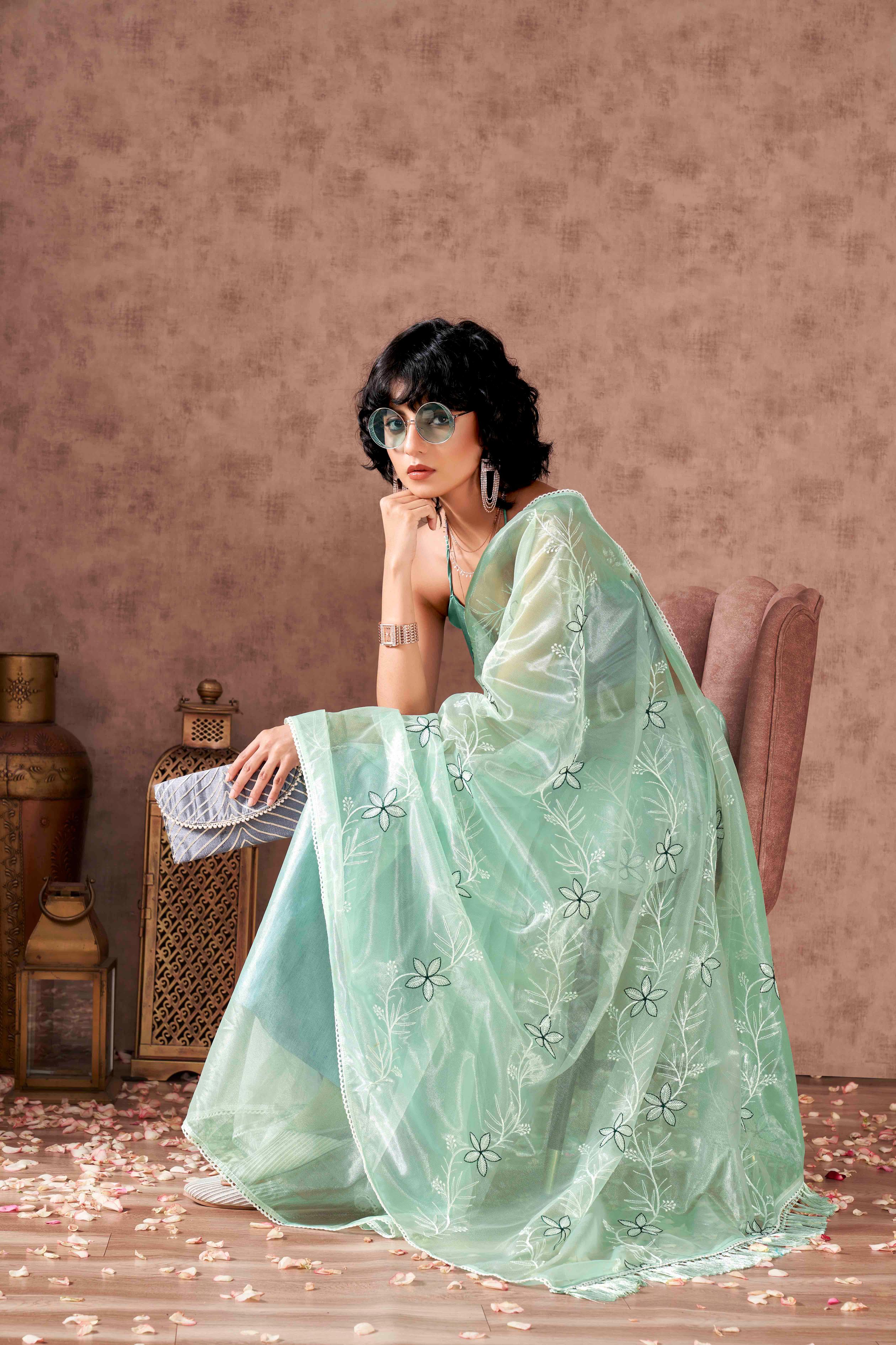 Sea Green colored half and half sequin embroidered net saree with embellished lace