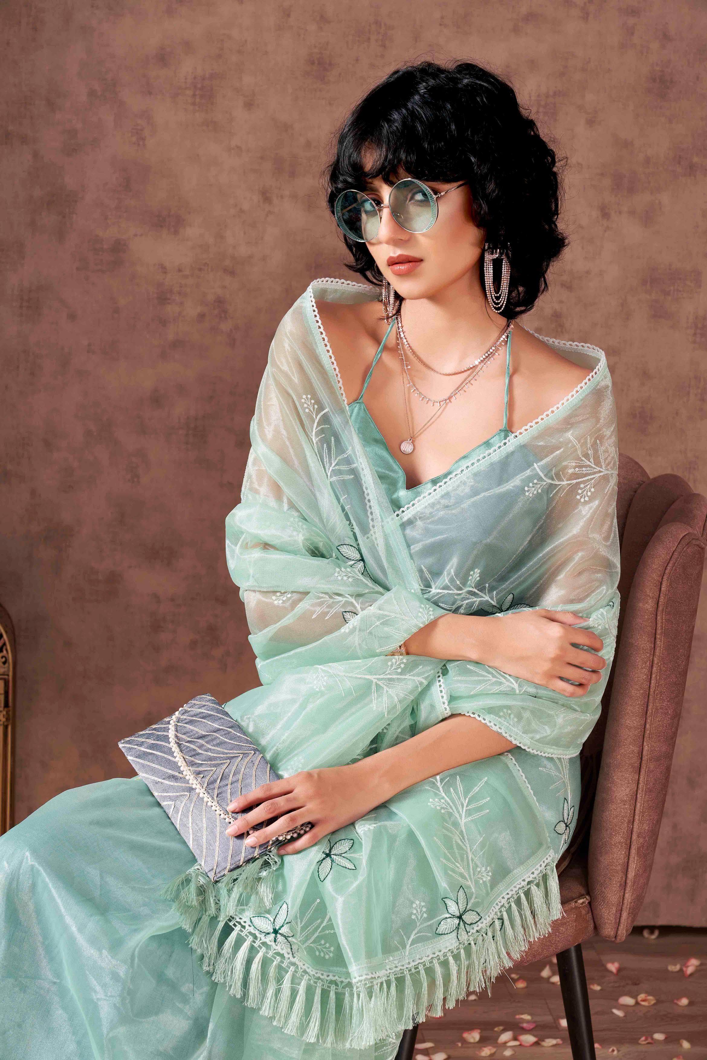 Sea Green colored half and half sequin embroidered net saree with embellished lace