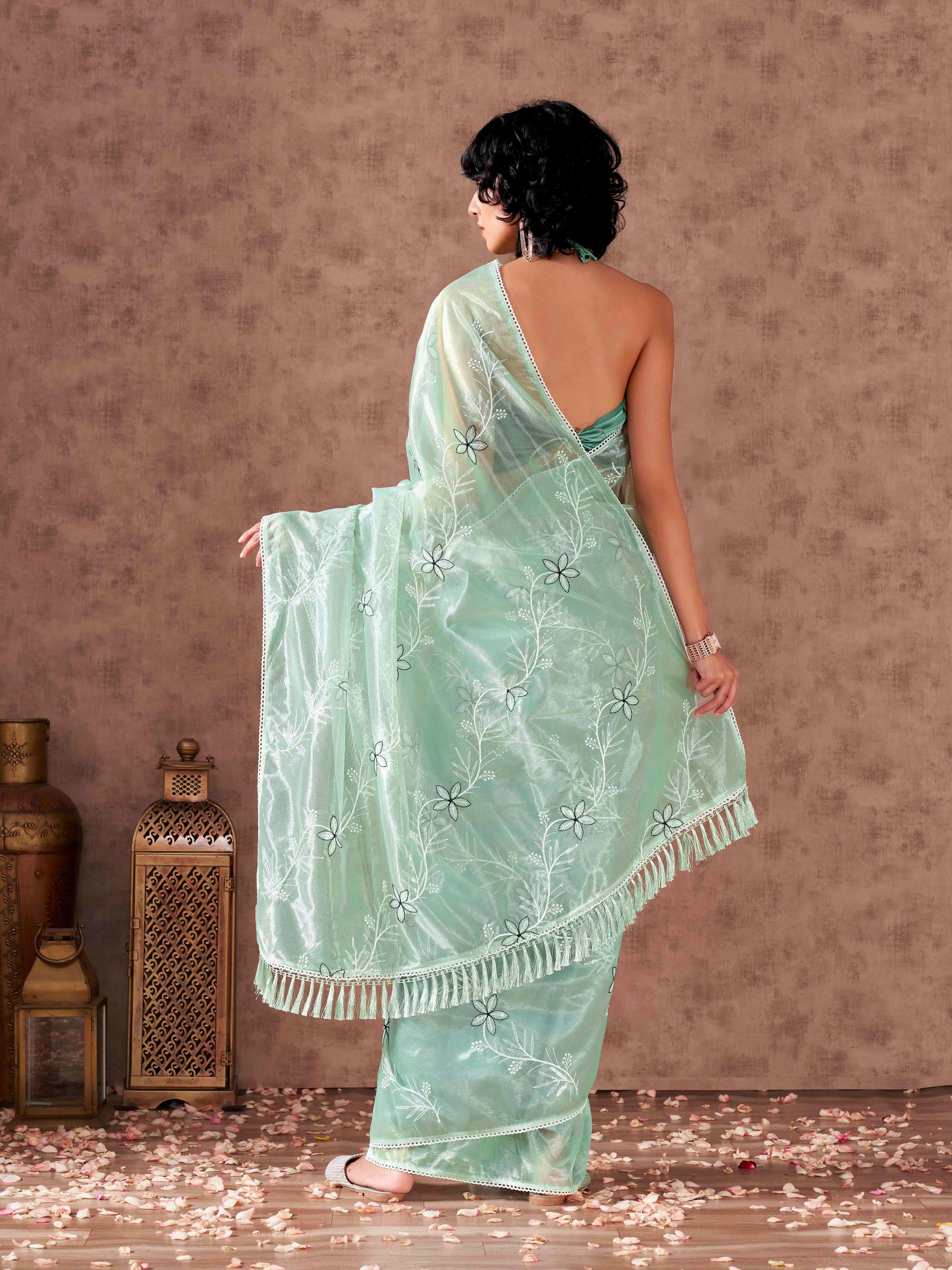 Sea Green colored half and half sequin embroidered net saree with embellished lace