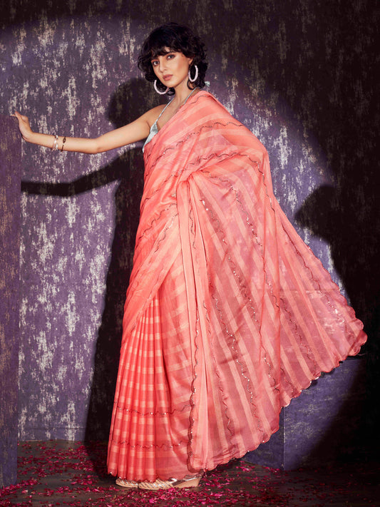 Peach colored satin striped saree with sequence embroidery and scalloped border